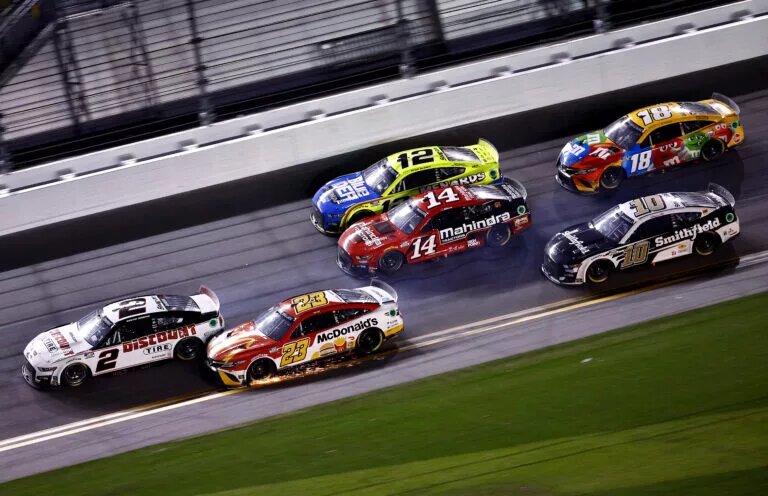 DAYTONA BEACH, FLORIDA - FEBRUARY 20: Austin Cindric, driver of the #2 Discount Tire Ford, and Bubba Wallace, driver of the #23 McDonald's Toyota, race to the finish of the NASCAR Cup Series 64th Annual Daytona 500 at Daytona International Speedway on February 20, 2022 in Daytona Beach, Florida. (Photo by Jared C. Tilton/Getty Images)