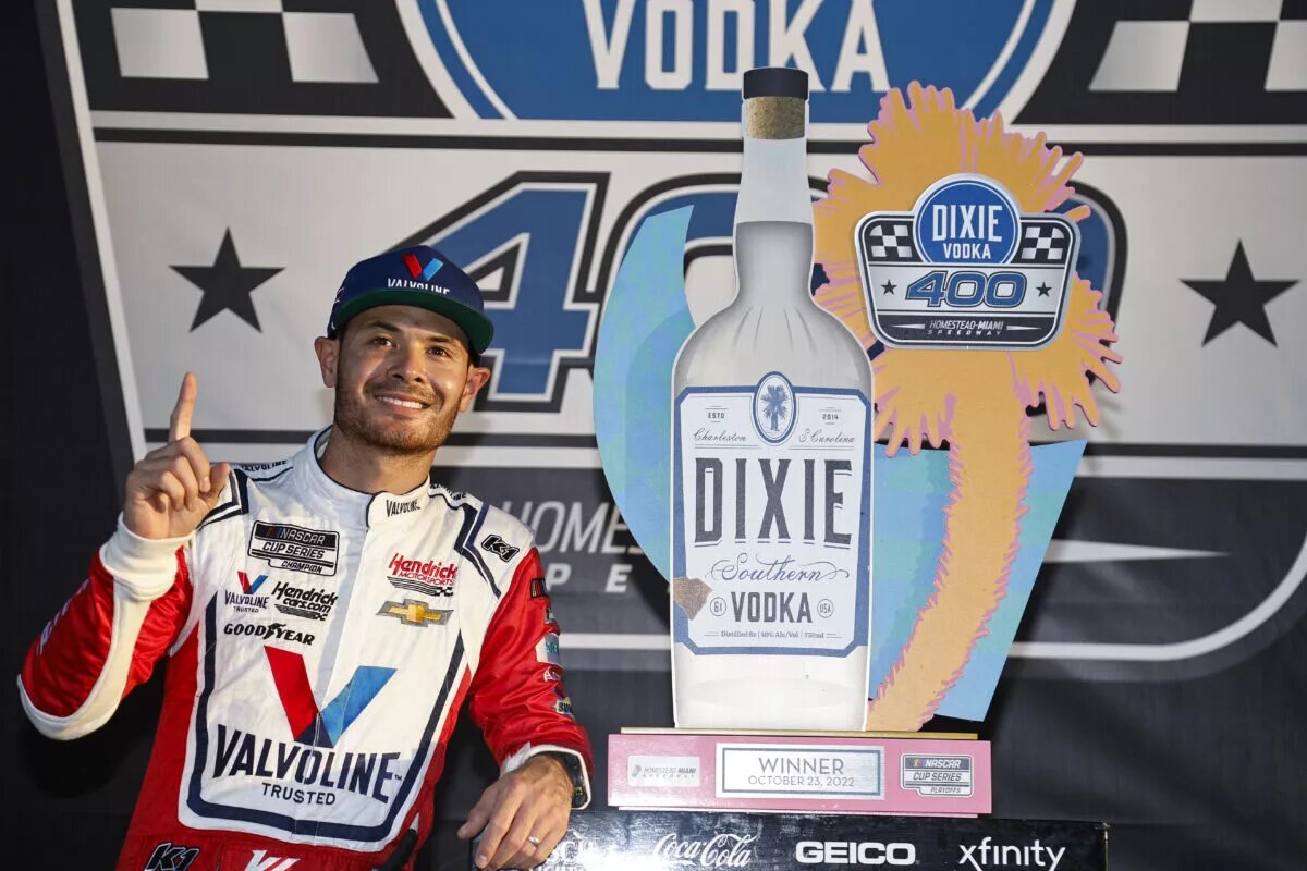 Kyle Larson poses with the trophy after winning the 2022 Dixie Vodka 400 at Homestead-Miami Speedway