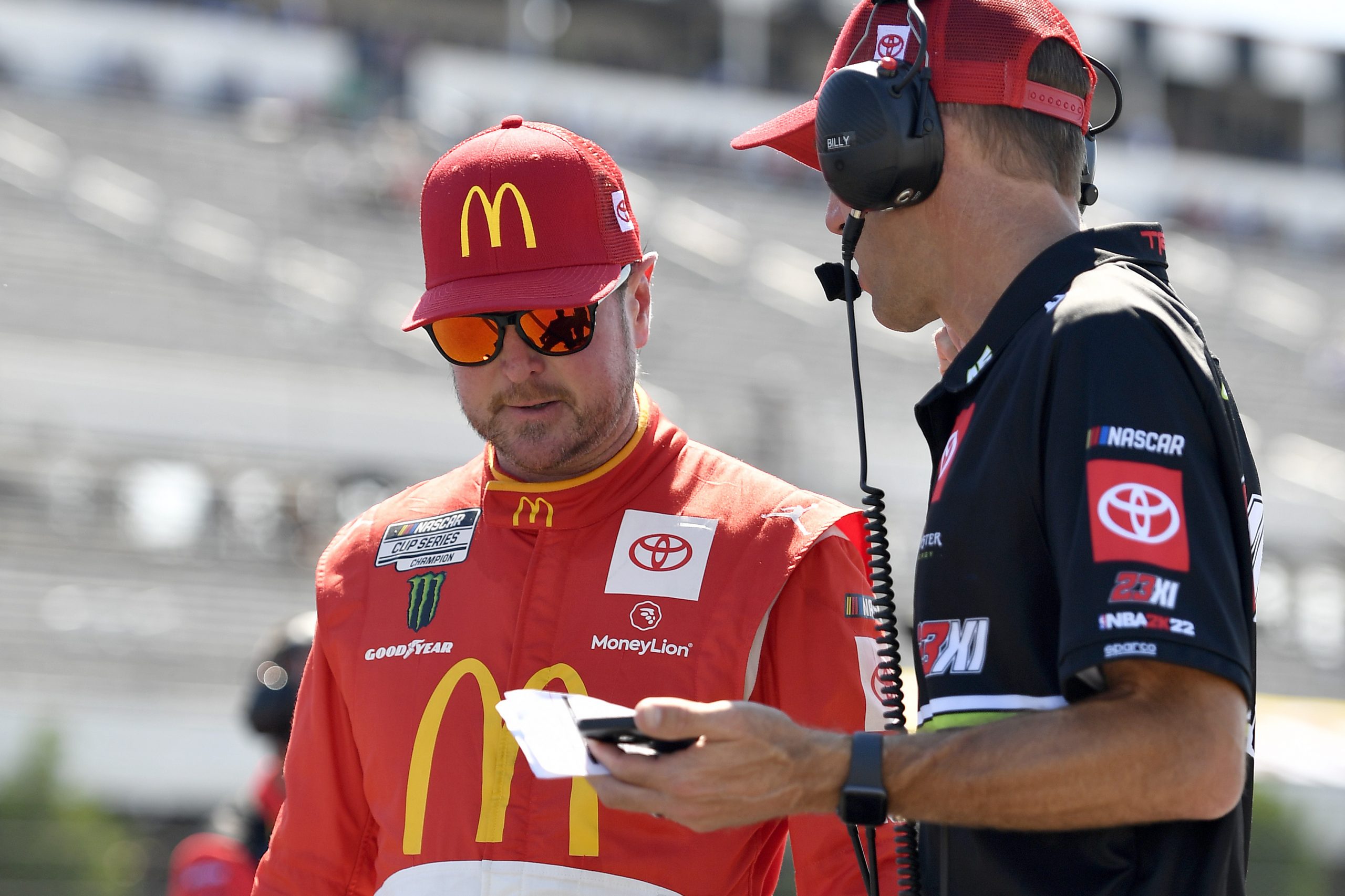 LONG POND, PENNSYLVANIA - JULY 23: Kurt Busch, driver of the #45 McDonald's Toyota, works with a crew member during qualifying for the NASCAR Cup Series M&M's Fan Appreciation 400 at Pocono Raceway on July 23, 2022 in Long Pond, Pennsylvania. (Photo by Logan Riely/Getty Images)