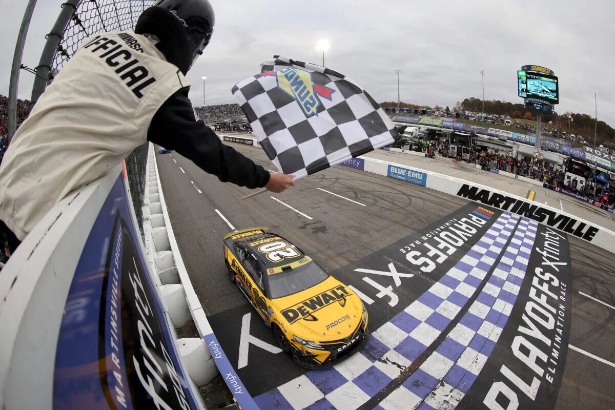 MARTINSVILLE, VIRGINIA - OCTOBER 30: Christopher Bell, driver of the #20 DeWalt Toyota, takes the checkered flag to win the NASCAR Cup Series Xfinity 500 at Martinsville Speedway on October 30, 2022 in Martinsville, Virginia. (Photo by Mike Mulholland/Getty Images)