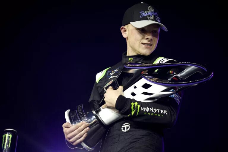 AVONDALE, ARIZONA - NOVEMBER 05: Ty Gibbs, driver of the #54 Monster Energy Toyota, embraces the 2022 NASCAR Xfinity Series Championship trophy in victory lane after winning the NASCAR Xfinity Series Championship at Phoenix Raceway on November 05, 2022 in Avondale, Arizona. (Photo by Jared C. Tilton/Getty Images)