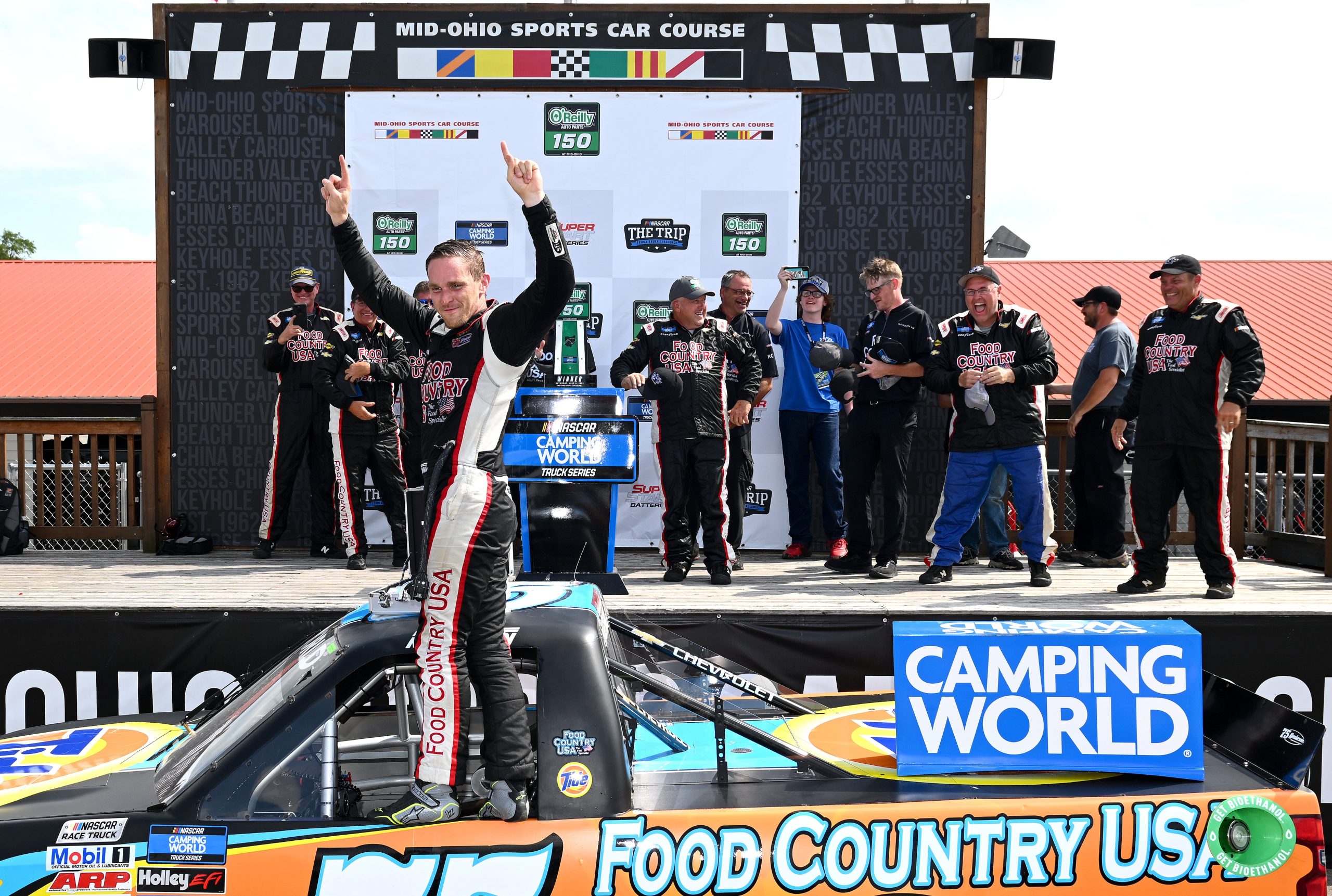 LEXINGTON, OHIO - JULY 09: Parker Kligerman, driver of the #75 Food Country USA/Tide Chevrolet, celebrates in victory lane after winning the NASCAR Camping World Truck Series O'Reilly Auto Parts 150 at Mid-Ohio Sports Car Course on July 09, 2022 in Lexington, Ohio. (Photo by Ben Jackson/Getty Images)