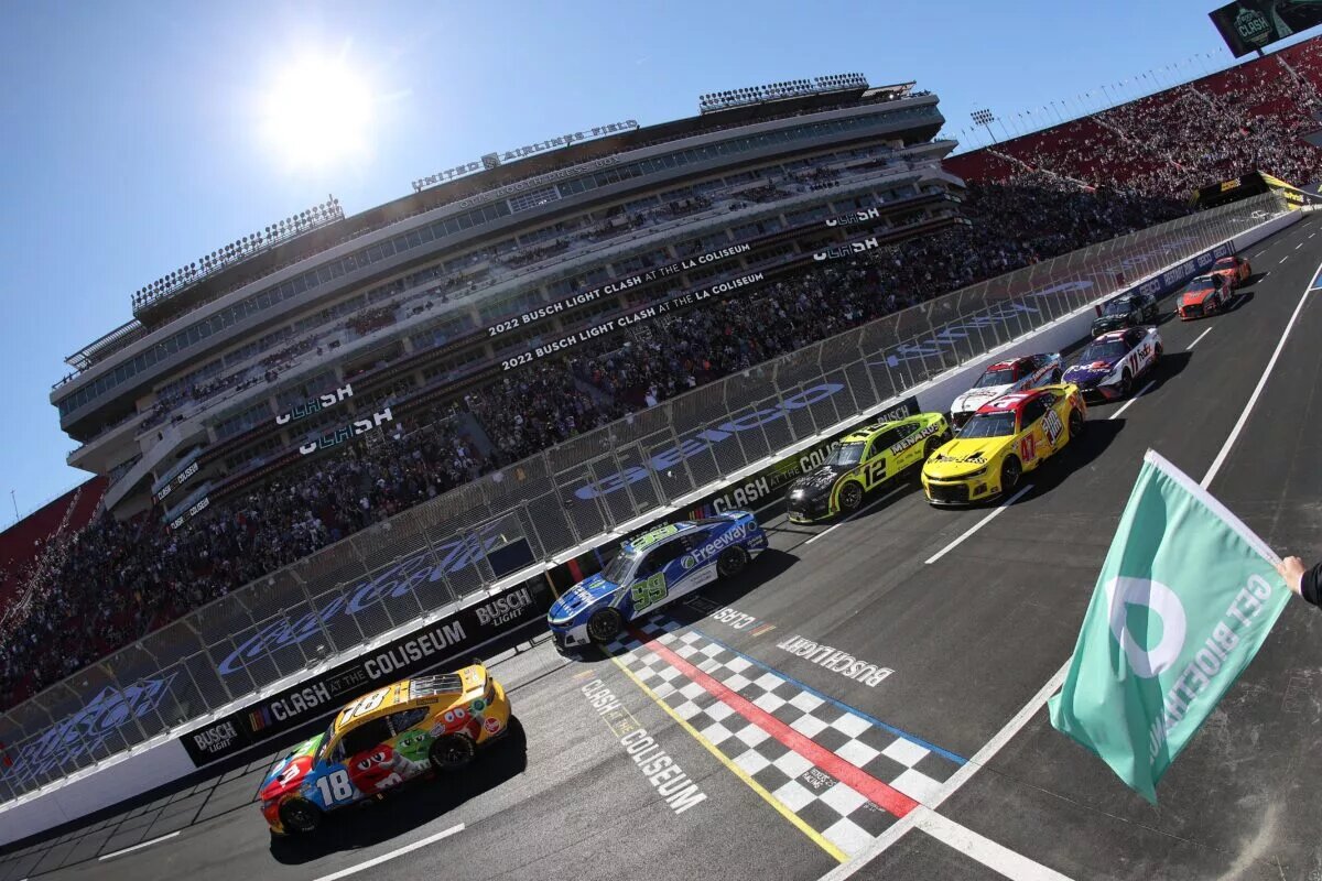 LOS ANGELES, CALIFORNIA - FEBRUARY 06: Kyle Busch, driver of the #18 M&M's Toyota, leads Daniel Suarez, driver of the #99 Freeway Insurance Chevrolet, Ryan Blaney, driver of the #12 Menards/Great Lakes Flooring Ford, and Ricky Stenhouse Jr., driver of the #47 Food 4 Less Chevrolet, in the NASCAR Cup Series Busch Light Clash qualifying heat at the Los Angeles Memorial Coliseum on February 06, 2022 in Los Angeles, California. (Photo by Sean Gardner/Getty Images)