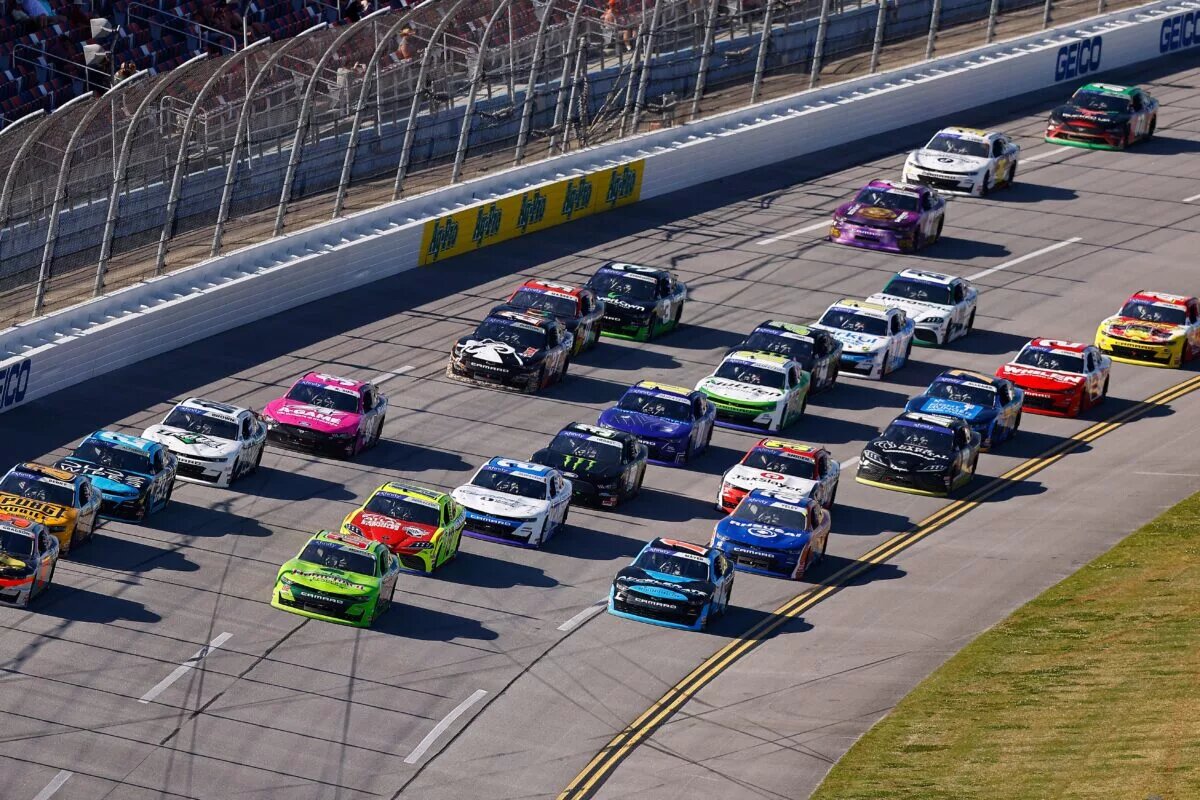 TALLADEGA, ALABAMA - APRIL 23: Noah Gragson, driver of the #9 Bass Pro Shops/TrueTimber/BRCC Chevrolet, Brett Moffitt, driver of the #02 Hometown Lenders Chevrolet, and Sam Mayer, driver of the #1 Accelerate Pros Talent Chevrolet, race during the NASCAR Xfinity Series Ag-Pro 300 at Talladega Superspeedway on April 23, 2022 in Talladega, Alabama. (Photo by James Gilbert/Getty Images)