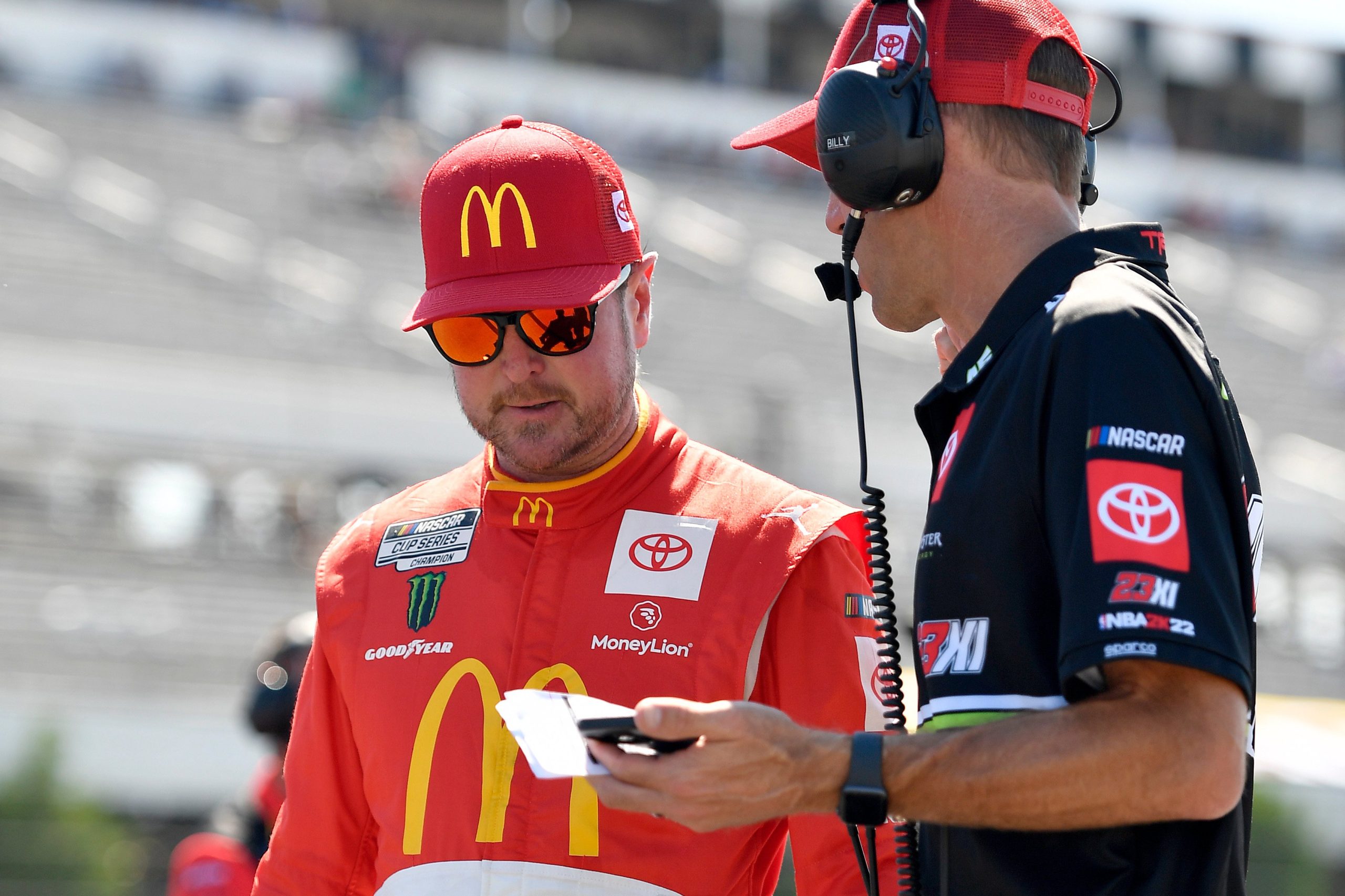 LONG POND, PENNSYLVANIA - JULY 23: Kurt Busch, driver of the #45 McDonald's Toyota, works with a crew member during qualifying for the NASCAR Cup Series M&M's Fan Appreciation 400 at Pocono Raceway on July 23, 2022 in Long Pond, Pennsylvania. (Photo by Logan Riely/Getty Images)