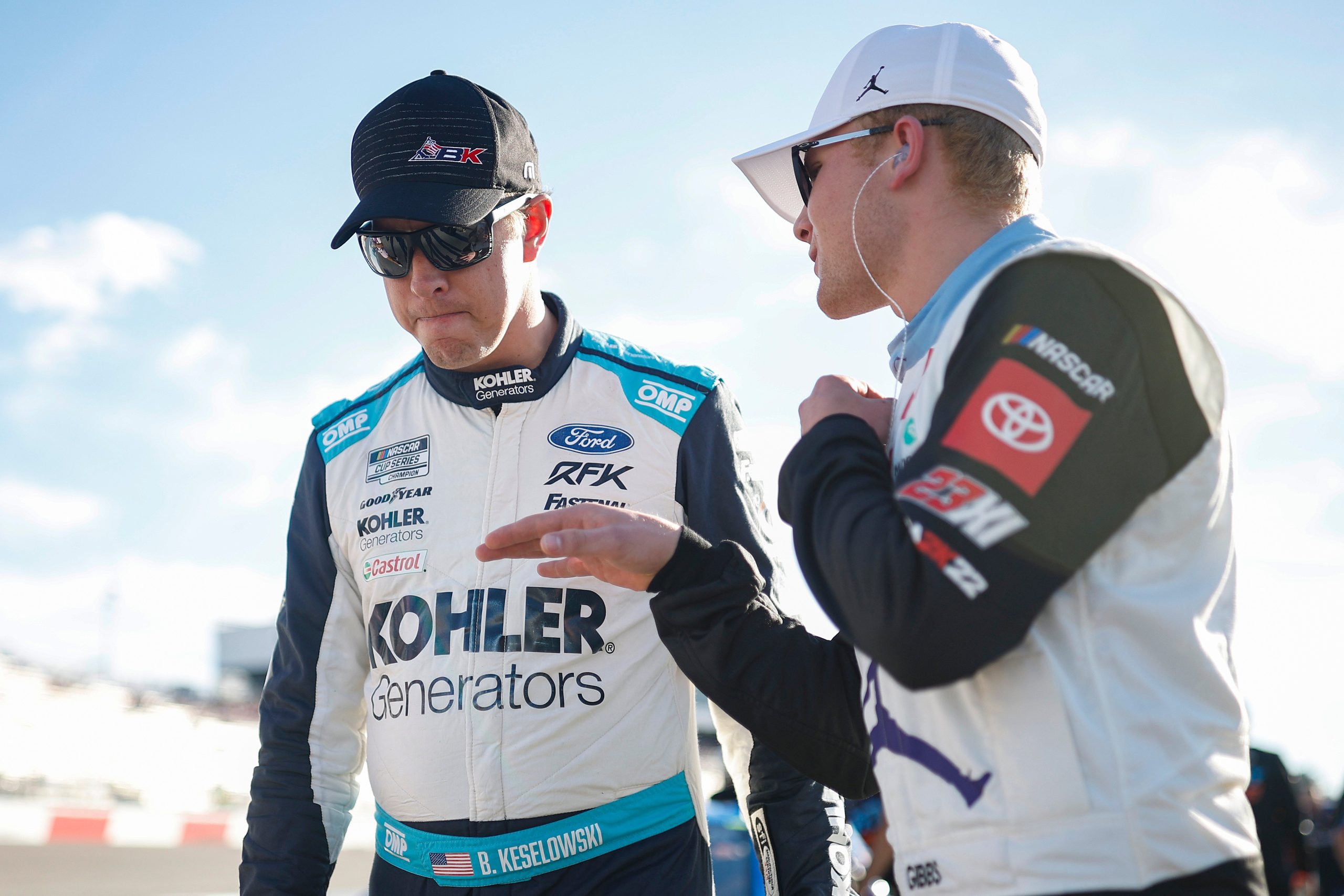 RICHMOND, VIRGINIA - AUGUST 13: Brad Keselowski, driver of the #6 RoushParts.com Ford, (L) and Ty Gibbs, driver of the #45 Jordan Brand Toyota, talk on the grid during practice for the NASCAR Camping World Truck Series Worldwide Express 250 for Carrier Appreciation at Richmond Raceway on August 13, 2022 in Richmond, Virginia. (Photo by Jared C. Tilton/Getty Images)