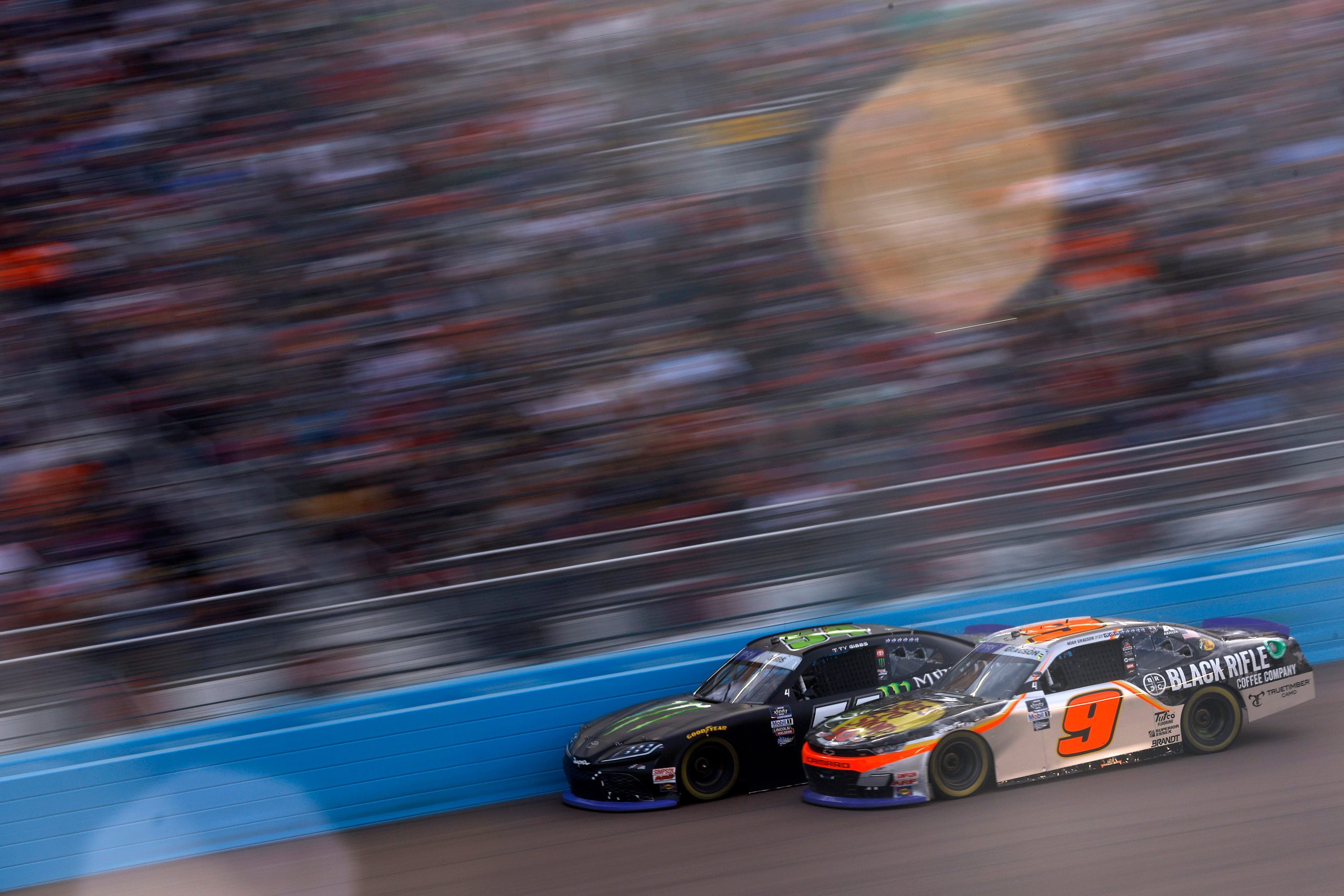 AVONDALE, ARIZONA - NOVEMBER 05: Ty Gibbs, driver of the #54 Monster Energy Toyota, and Noah Gragson, driver of the #9 Bass Pro Shops/TrueTimber/BRCC Chevrolet, race during the NASCAR Xfinity Series Championship at Phoenix Raceway on November 05, 2022 in Avondale, Arizona. (Photo by Jared C. Tilton/Getty Images)