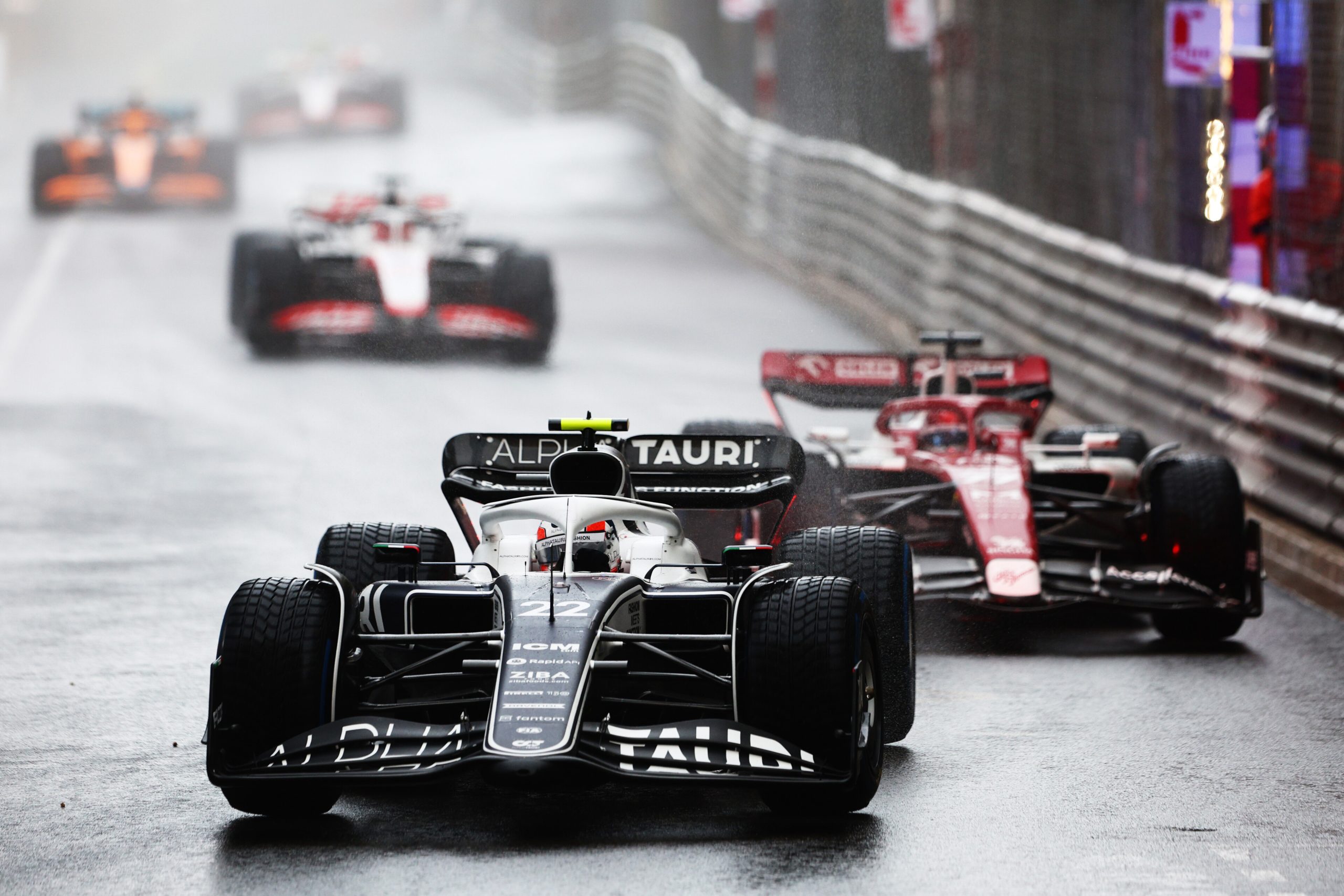 MONTE-CARLO, MONACO - MAY 29: Yuki Tsunoda of Japan driving the (22) Scuderia AlphaTauri AT03 ; Valtteri Bottas of Finland driving the (77) Alfa Romeo F1 C42 Ferrari on a formation lap in the rain during the F1 Grand Prix of Monaco at Circuit de Monaco on May 29, 2022 in Monte-Carlo, Monaco. (Photo by Clive Rose/Getty Images) // Getty Images / Red Bull Content Pool // SI202205290262 // Usage for editorial use only //