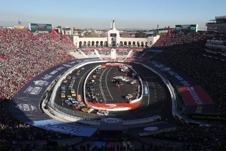 LOS ANGELES, CALIFORNIA - FEBRUARY 06: Kyle Busch, driver of the #18 M&M's Toyota, and Tyler Reddick, driver of the #8 Guaranteed Rate Chevrolet, lead the field during the NASCAR Cup Series Busch Light Clash at the Los Angeles Memorial Coliseum on February 06, 2022 in Los Angeles, California. (Photo by Meg Oliphant/Getty Images)