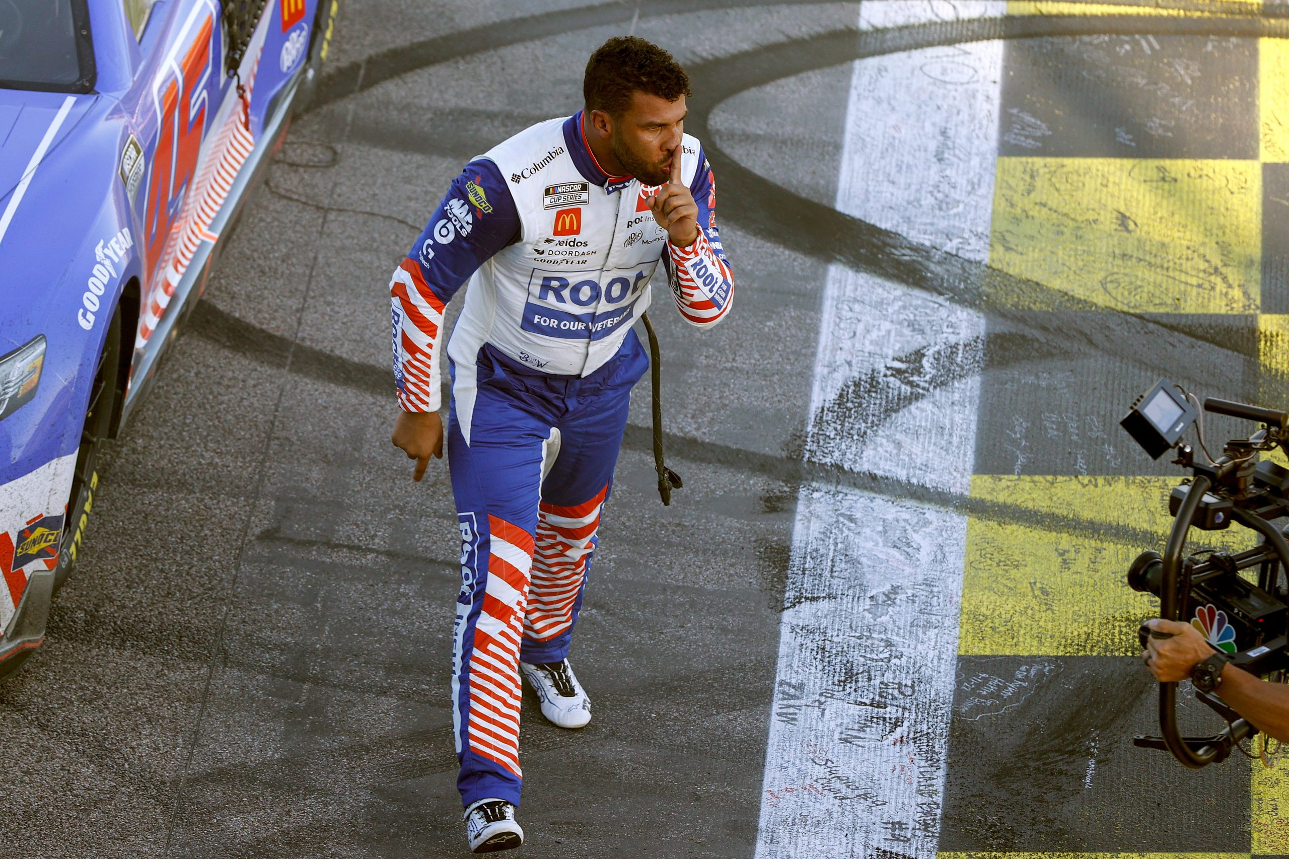 KANSAS CITY, KANSAS - SEPTEMBER 11: Bubba Wallace, driver of the #45 ROOT Insurance Toyota, gestures to the camera after winning the NASCAR Cup Series Hollywood Casino 400 at Kansas Speedway on September 11, 2022 in Kansas City, Kansas. (Photo by Meg Oliphant/Getty Images)