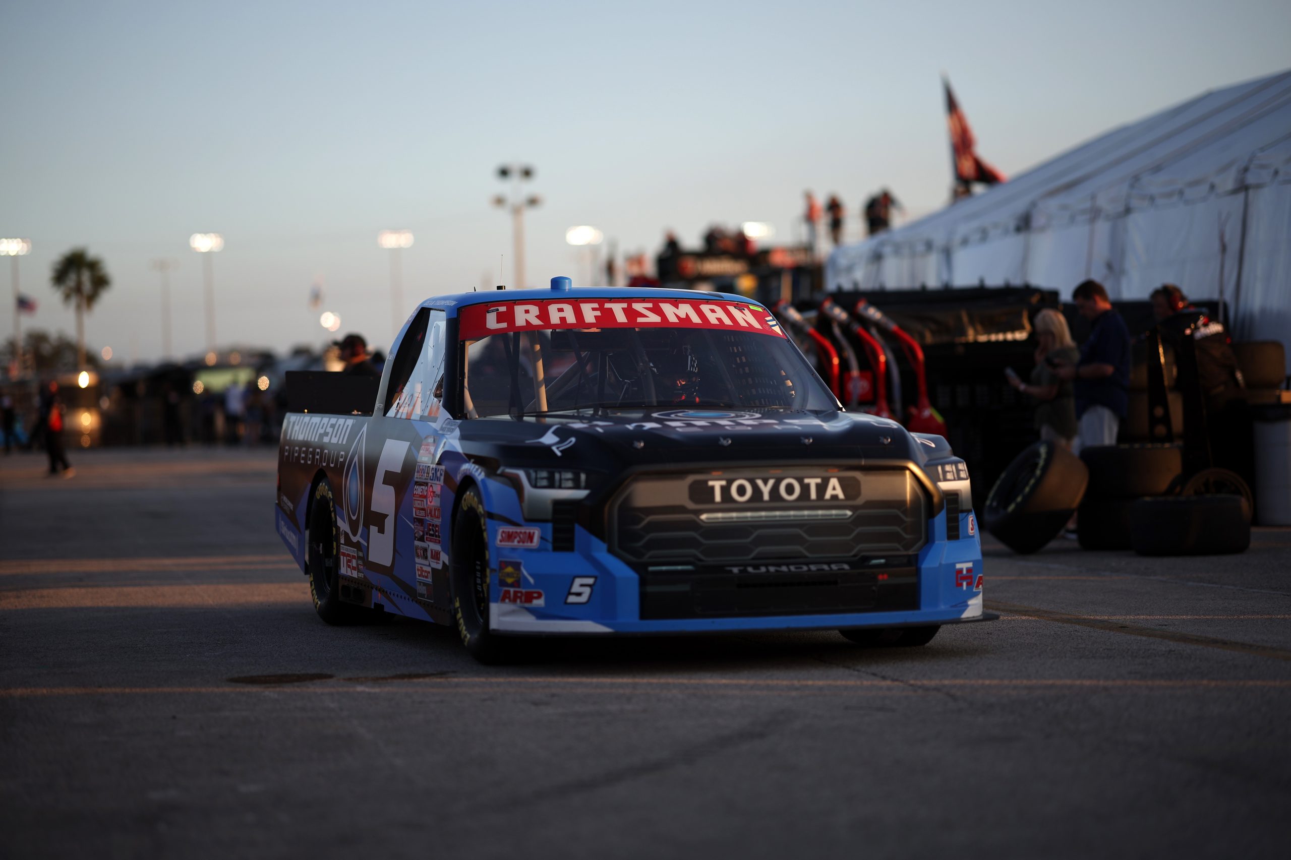 DAYTONA BEACH, FLORIDA - FEBRUARY 16: Dean Thompson, driver of the #5 Thompson Pipe Group Toyota, drives thought the garage area during practice for the NASCAR Craftsman Truck Series NextEra Energy 250 at Daytona International Speedway on February 16, 2023 in Daytona Beach, Florida. (Photo by James Gilbert/Getty Images)