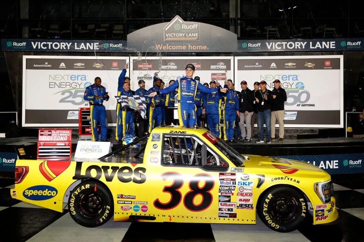 DAYTONA BEACH, FLORIDA - FEBRUARY 17: Zane Smith, driver of the #38 Love's/Speedco Ford, celebrates in victory lane after winning the rain-delayed NASCAR Craftsman Truck Series NextEra Energy 250 at Daytona International Speedway on February 17, 2023 in Daytona Beach, Florida. (Photo by Chris Graythen/Getty Images)