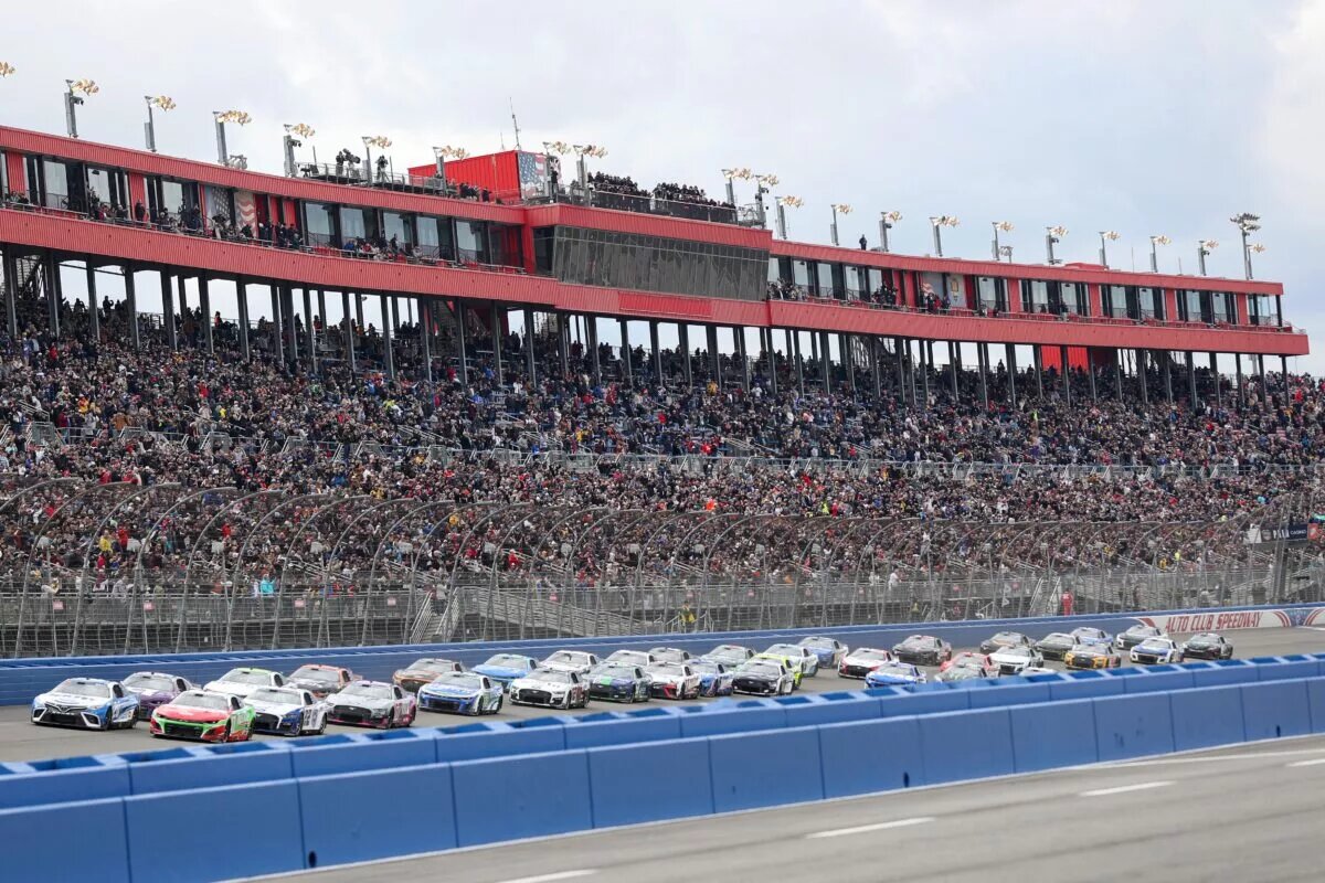 FONTANA, CALIFORNIA - FEBRUARY 26: Christopher Bell, driver of the #20 Sirius XM Toyota, and Ricky Stenhouse Jr, driver of the #47 Ralphs/Tree Top Chevrolet, lead the field to start the NASCAR Cup Series Pala Casino 400 at Auto Club Speedway on February 26, 2023 in Fontana, California. (Photo by Meg Oliphant/Getty Images)