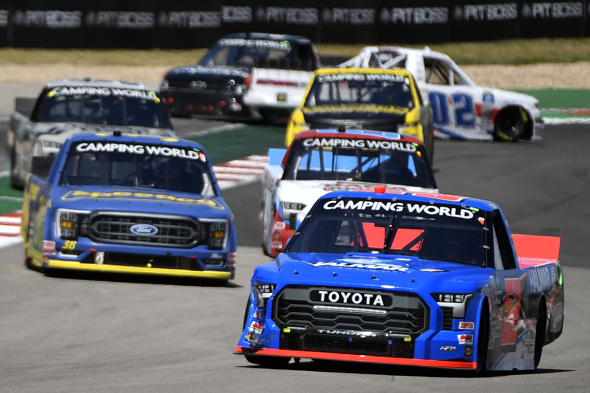 AUSTIN, TEXAS - MARCH 26: Stewart Friesen, driver of the #52 Halmar International Toyota, drives as Kaz Grala, driver of the #02 RANDCO Industries Chevrolet, spins after an on-track incident during the NASCAR Camping World Truck Series - XPEL 225 at Circuit of The Americas on March 26, 2022 in Austin, Texas. (Photo by Logan Riely/Getty Images)