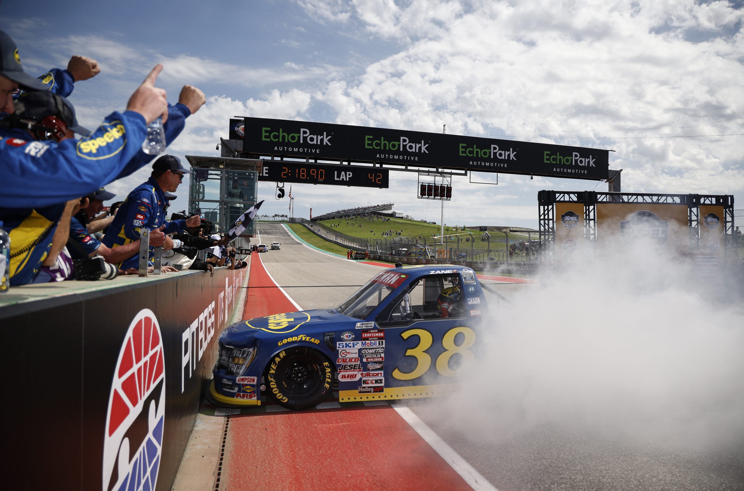 AUSTIN, TEXAS - MARCH 25: Zane Smith, driver of the #38 Speedco/Peak Ford, celebrates with a burnout after winning the NASCAR Craftsman Truck Series XPEL 225 at Circuit of The Americas on March 25, 2023 in Austin, Texas. (Photo by Chris Graythen/Getty Images)