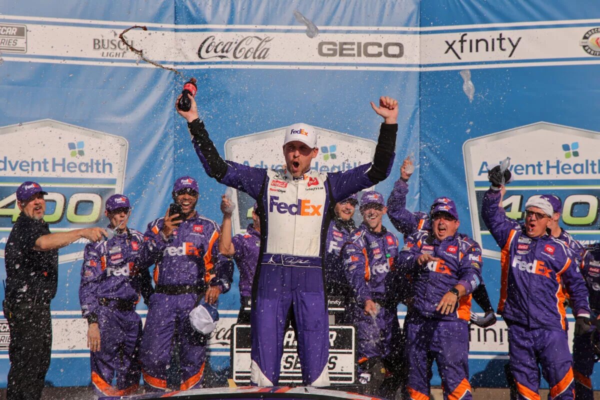 KANSAS CITY, KANSAS - MAY 07: Denny Hamlin, driver of the #11 FedEx Express Toyota, celebrates in victory lane after winning the NASCAR Cup Series Advent Health 400 at Kansas Speedway on May 07, 2023 in Kansas City, Kansas. (Photo by Jonathan Bachman/Getty Images)