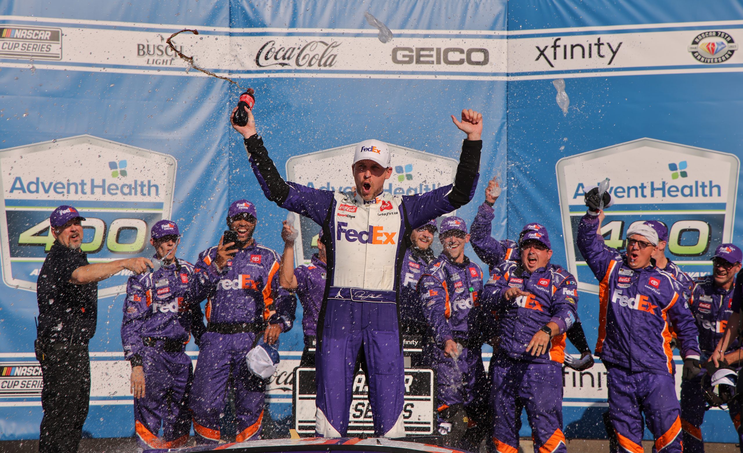 KANSAS CITY, KANSAS - MAY 07: Denny Hamlin, driver of the #11 FedEx Express Toyota, celebrates in victory lane after winning the NASCAR Cup Series Advent Health 400 at Kansas Speedway on May 07, 2023 in Kansas City, Kansas. (Photo by Jonathan Bachman/Getty Images)