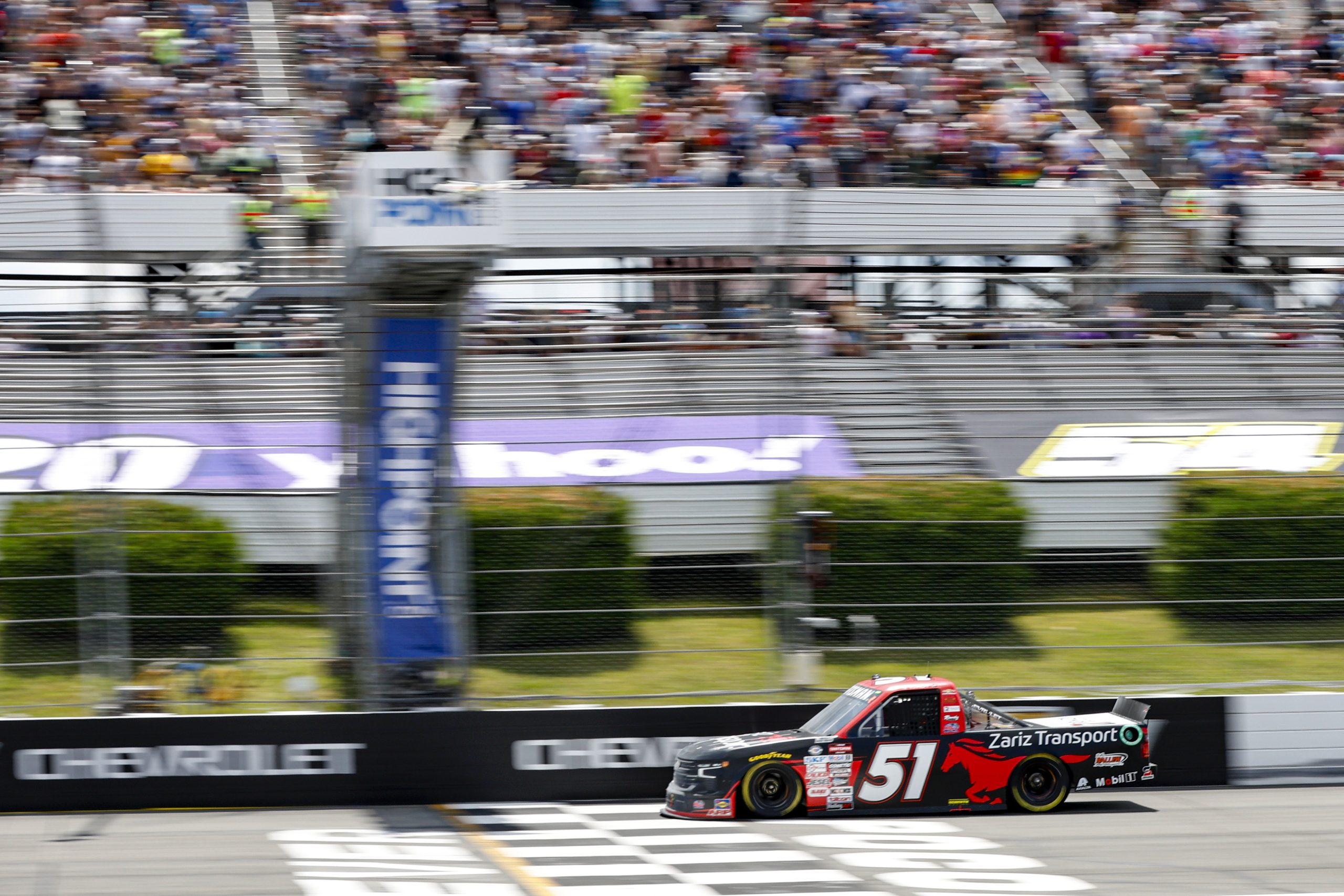 Kyle Busch, driver of the #51 Zariz Transport Chevrolet, crosses the finish line to win the NASCAR Craftsman Truck Series CRC Brakleen 150 at Pocono Raceway on July 22, 2023