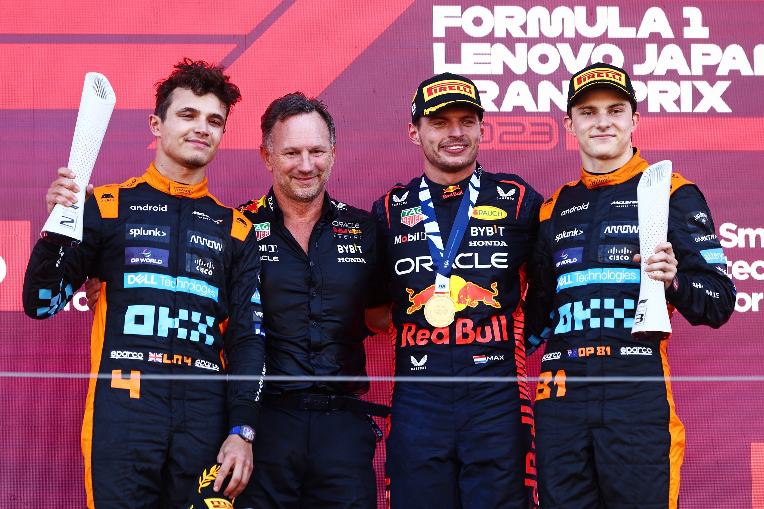 Lando Norris and Oscar Piastri of McLaren, on the podium with Max Verstappen and Christian Horner, Japanese Grand Prix 2023.
