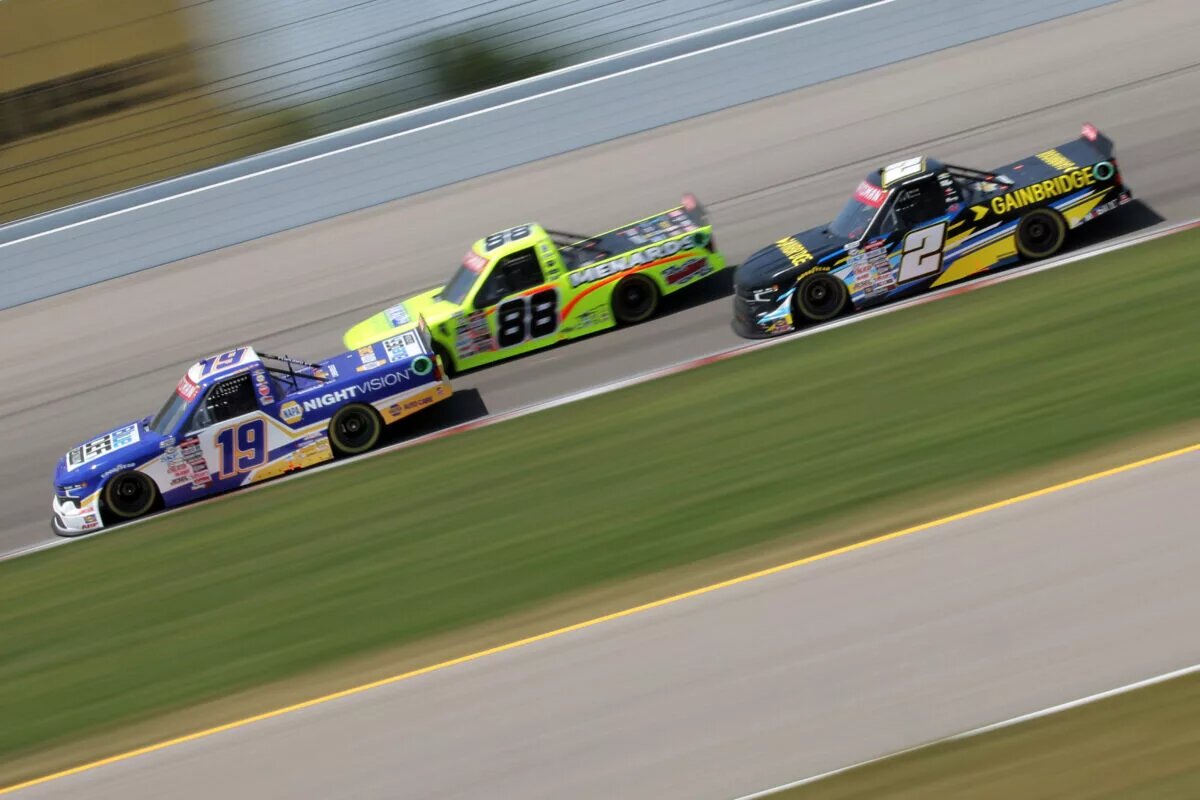 Christian Eckes, driver of the #19 BlueDEF Platinum Chevrolet, Matt Crafton, driver of the #88 Ideal Door/Menards Ford, and Nick Sanchez, driver of the #2 Gainbridge Chevrolet, race during the NASCAR Craftsman Truck Series Toyota 200 at WWT Raceway on June 03, 2023 in Madison, Illinois.