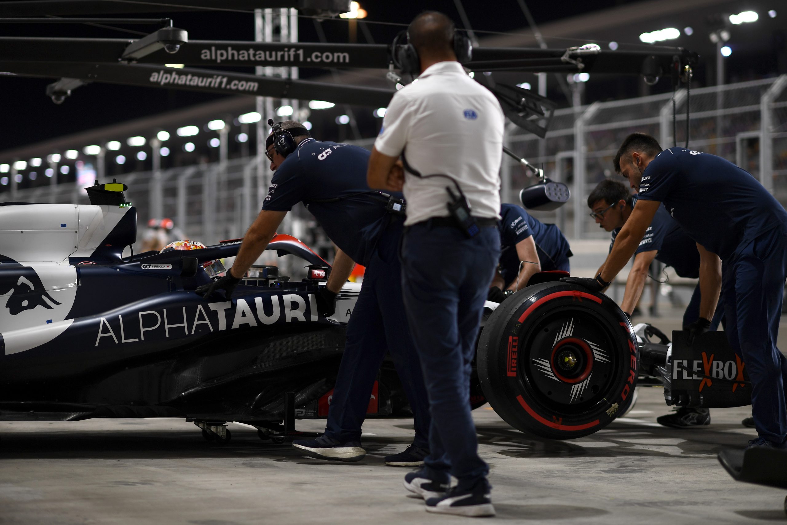 Yuki Tsunoda of Japan driving the (22) Scuderia AlphaTauri AT04 is pushed back into the garage during qualifying ahead of the F1 Grand Prix of Qatar at Lusail International Circuit on October 06, 2023 in Lusail City, Qatar.