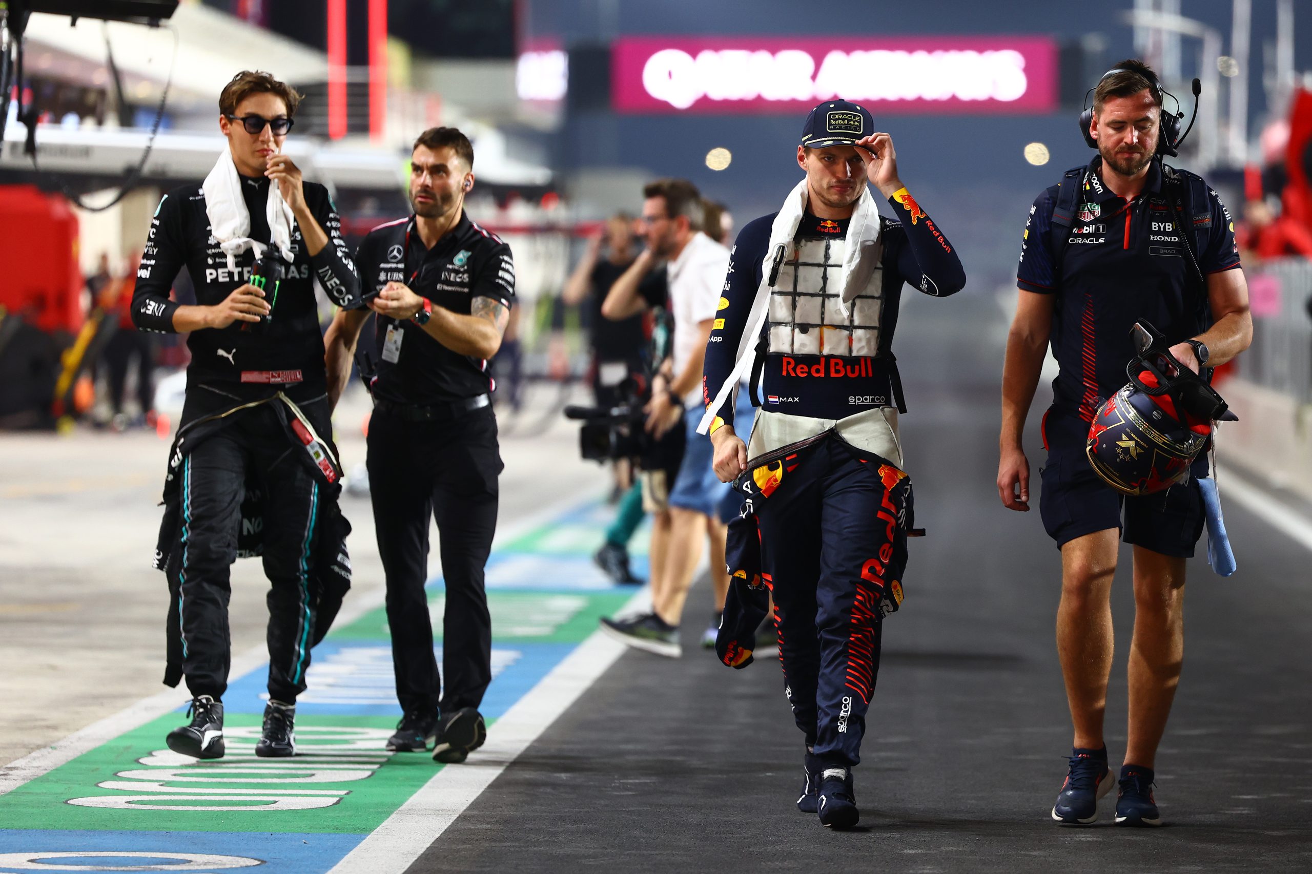 Max Verstappen of Red Bull Racing and George Russell of Mercedes walk to the grid prior to the F1 Grand Prix of Qatar, 2023