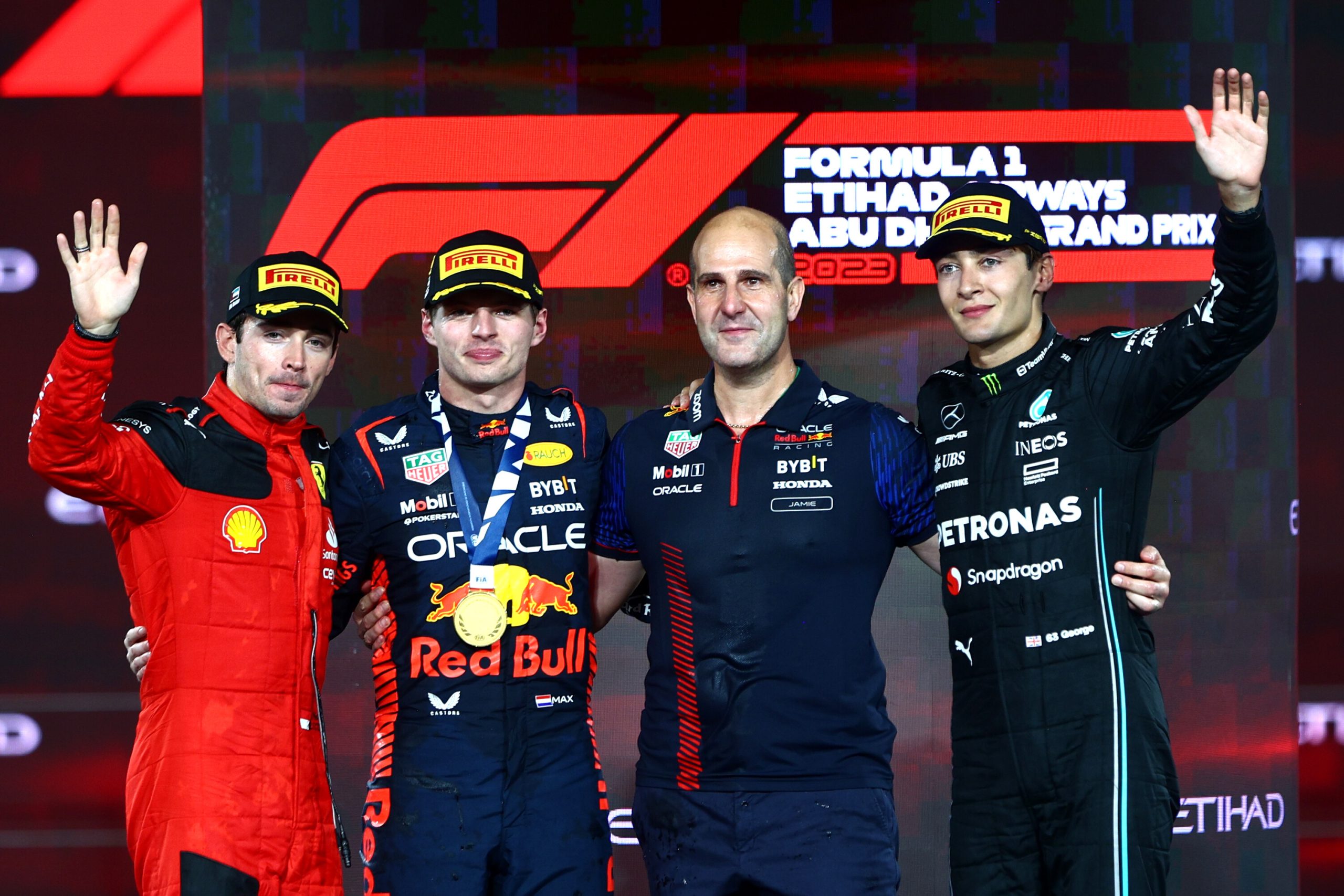 Max Verstappen of Red Bull Racing, Charles Leclerc of Ferrari and George Russell of Mercedes on the podium at the Abu Dhabi Grand Prix, 2023