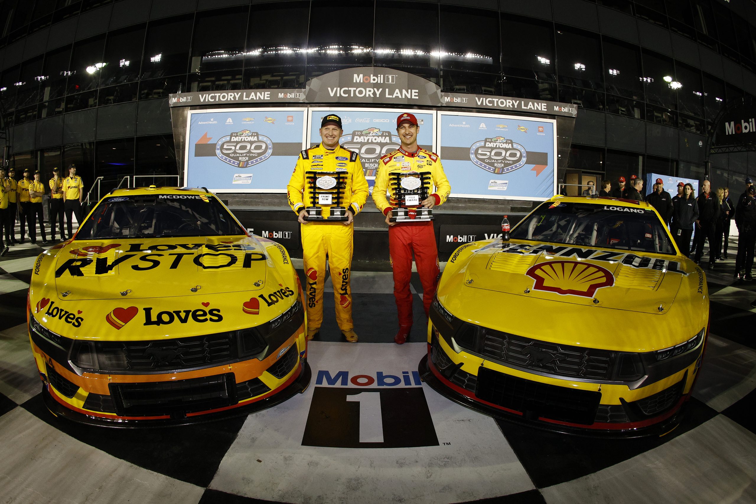 Joey Logano, driver of the #22 Shell Pennzoil Ford, (R) winner of the Daytona 500 pole award and Michael McDowell, driver of the #34 Love's Travel Stops Ford, Front Row second fastest winner pose for a photo during qualifying for the NASCAR Cup Series Daytona 500 at Daytona International Speedway on February 14, 2024 in Daytona Beach, Florida. daytona 500 pole