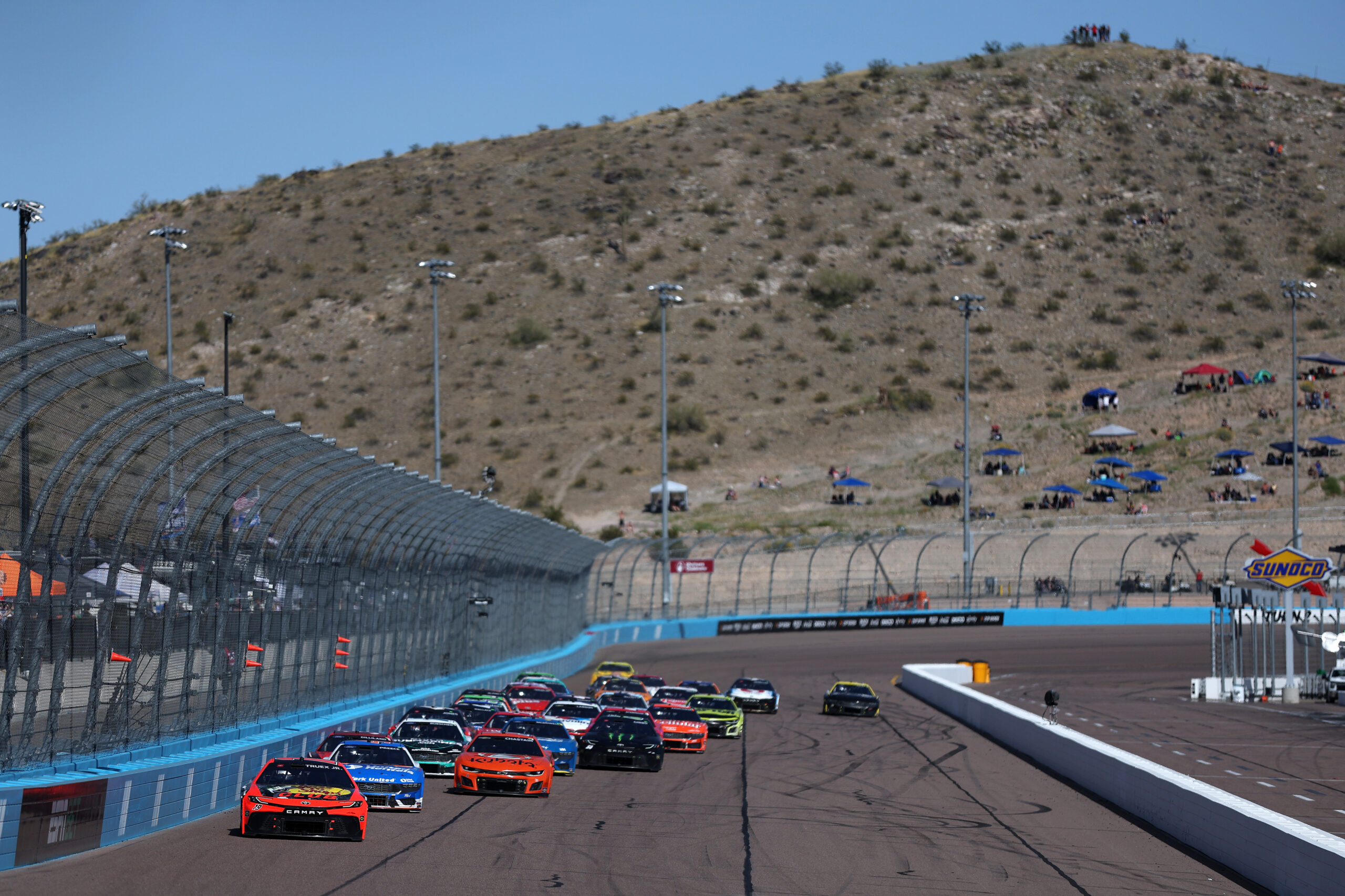 Martin Truex Jr., driver of the #19 Bass Pro Shops Toyota, leads the field during the NASCAR Cup Series Shriners Children's 500 at Phoenix Raceway on March 10, 2024 in Avondale, Arizona. NASCAR's Horsepower War