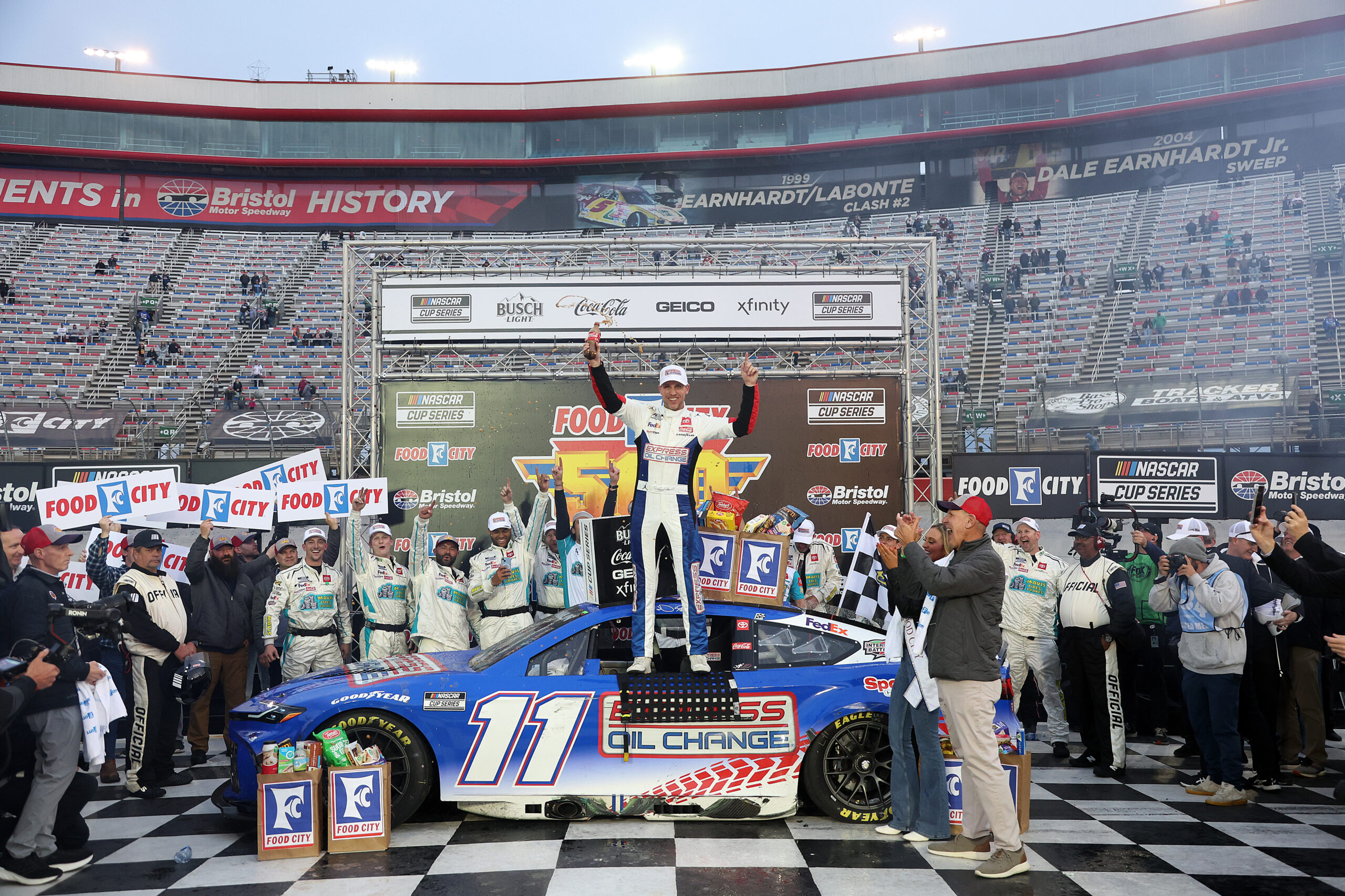 BRISTOL, TENNESSEE - MARCH 17: Denny Hamlin, driver of the #11 Express Oil Change Toyota, celebrates in victory lane after winning the NASCAR Cup Series Food City 500 at Bristol Motor Speedway on March 17, 2024 in Bristol, Tennessee. (Photo by Meg Oliphant/Getty Images)