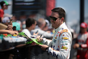 LONG POND, PENNSYLVANIA - JULY 13: Alex Bowman, driver of the #48 Ally Best Friends Chevrolet, signs autographs for NASCAR fans during practice for the NASCAR Cup Series The Great American Getaway 400 at Pocono Raceway on July 13, 2024 in Long Pond, Pennsylvania. (Photo by James Gilbert/Getty Images)