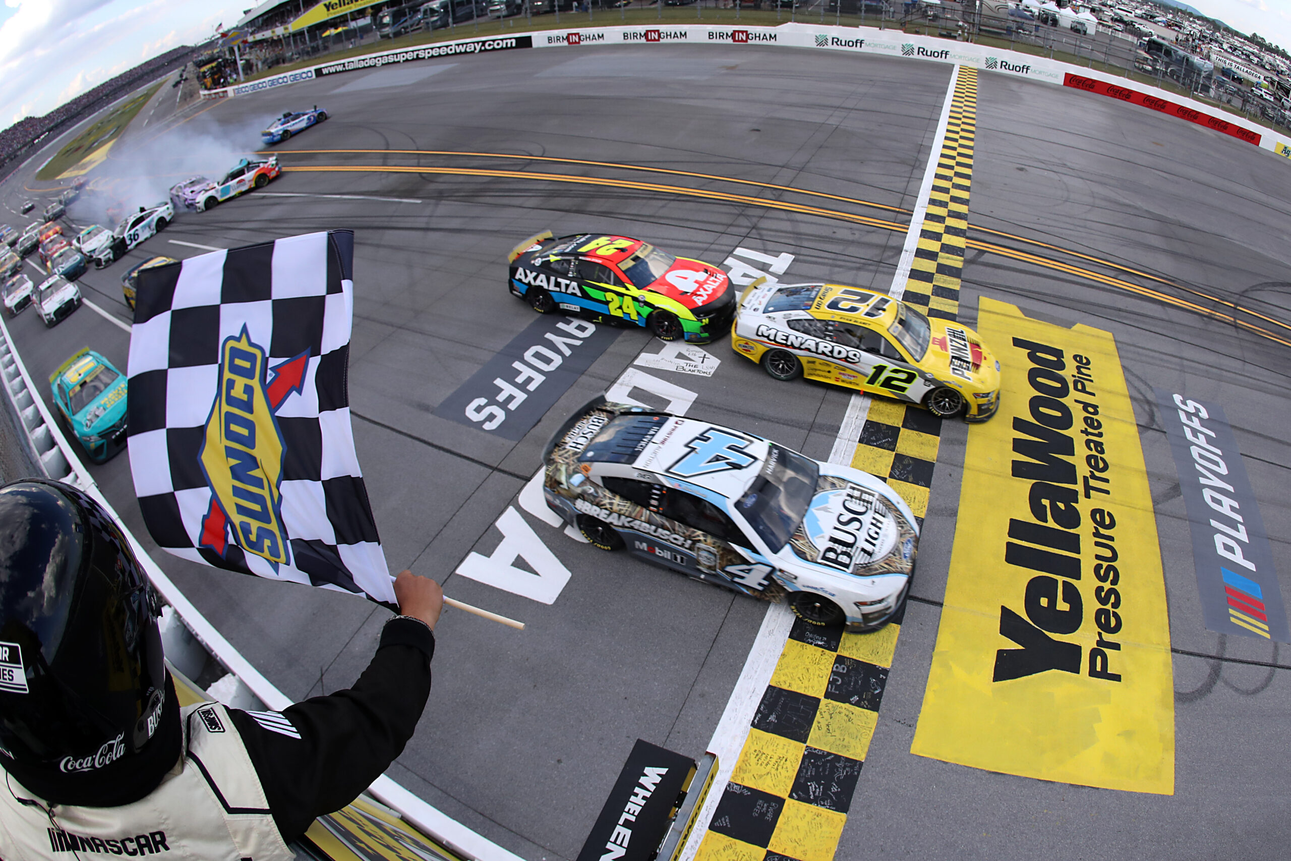 TALLADEGA, ALABAMA - OCTOBER 01: Ryan Blaney, driver of the #12 Menards/Pennzoil Ford, takes the crosses the finish line ahead of Kevin Harvick, driver of the #4 Busch Light Camo Ford, to win the NASCAR Cup Series YellaWood 500 at Talladega Superspeedway on October 01, 2023 in Talladega, Alabama. (Photo by Meg Oliphant/Getty Images)