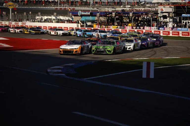 CONCORD, NORTH CAROLINA - OCTOBER 08: AJ Allmendinger, driver of the #16 Celsius Chevrolet, and Ty Gibbs, driver of the #54 Interstate Batteries All Battery Center Toyota, race during the NASCAR Cup Series Bank of America ROVAL 400 at Charlotte Motor Speedway on October 08, 2023 in Concord, North Carolina. (Photo by James Gilbert/Getty Images)