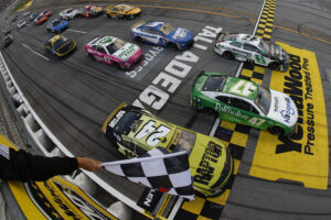 TALLADEGA, ALABAMA - OCTOBER 06: Ricky Stenhouse Jr., driver of the #47 Kroger Health/Palmolive Chevrolet, takes the checkered flag ahead of Brad Keselowski, driver of the #6 BuildSubmarines.com Ford, and William Byron, driver of the #24 RaptorTough.com Chevrolet, to win the NASCAR Cup Series YellaWood 500 at Talladega Superspeedway on October 06, 2024 in Talladega, Alabama.