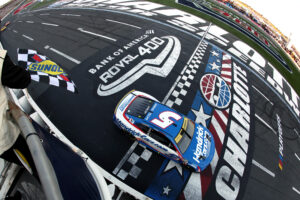 CONCORD, NORTH CAROLINA - OCTOBER 13: Kyle Larson, driver of the #5 HendrickCars.com Chevrolet, takes the checkered flag to win the NASCAR Cup Series Bank of America ROVAL 400 at Charlotte Motor Speedway on October 13, 2024 in Concord, North Carolina. (Photo by Meg Oliphant/Getty Images)