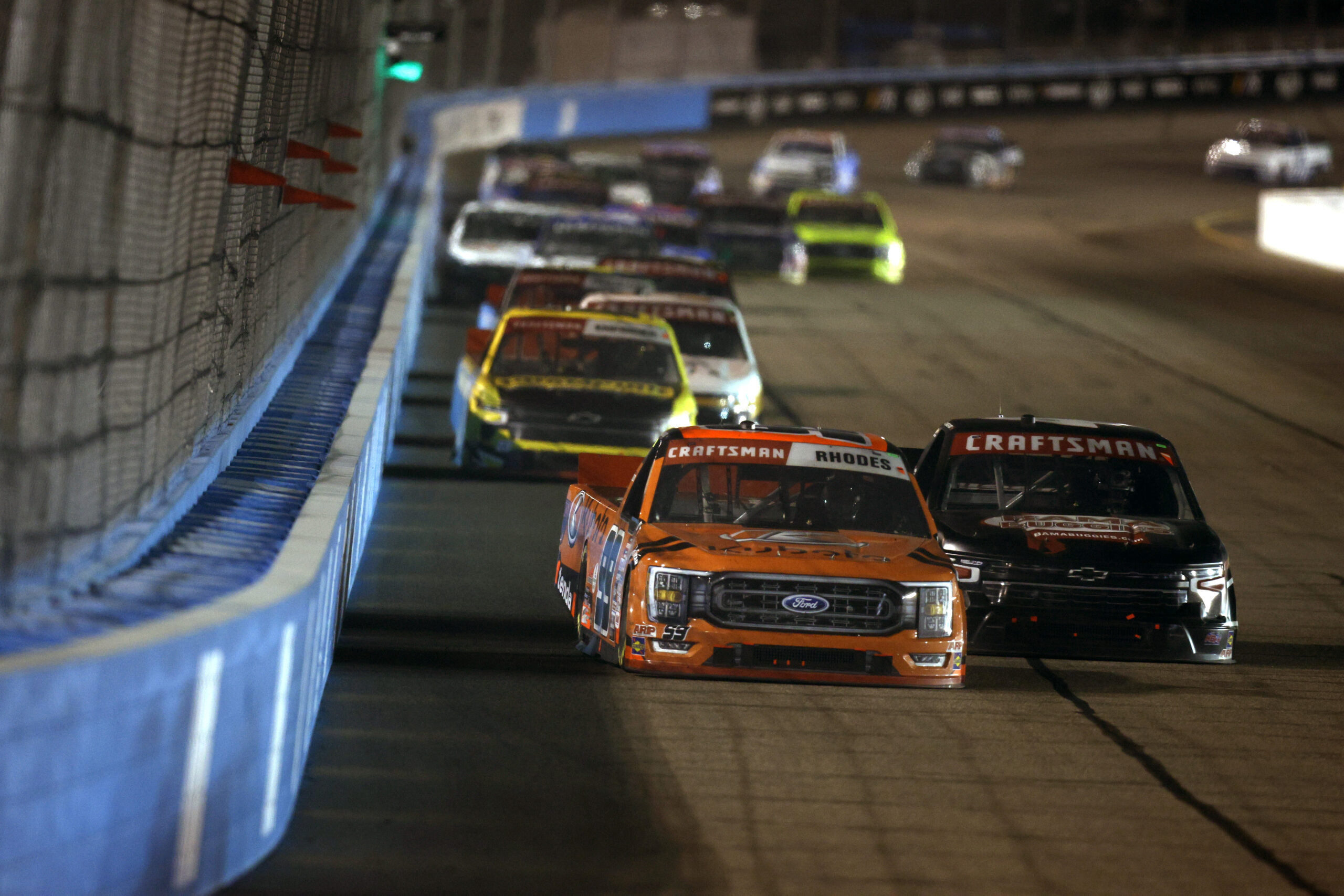 AVONDALE, ARIZONA - NOVEMBER 03: Ben Rhodes, driver of the #99 Kubota Ford, and Chase Purdy, driver of the #4 Bama Buggies Chevrolet, race during the NASCAR Craftsman Truck Series Craftsman 150 at Phoenix Raceway on November 03, 2023 in Avondale, Arizona. (Photo by Sean Gardner/Getty Images)