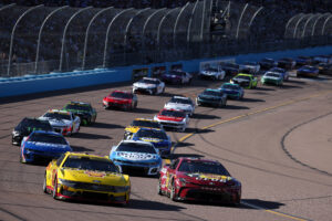 AVONDALE, ARIZONA - NOVEMBER 10: Martin Truex Jr., driver of the #19 Bass Pro Shops Toyota, and Joey Logano, driver of the #22 Shell Pennzoil Ford, lead the field during the NASCAR Cup Series Championship Race at Phoenix Raceway on November 10, 2024 in Avondale, Arizona. (Photo by James Gilbert/Getty Images)