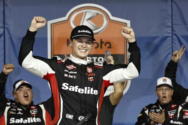 SEPTEMBER 27: Corey Heim, driver of the #11 Safelite Toyota, celebrates in victory lane after winning the NASCAR Craftsman Truck Series Kubota Tractor 200 at Kansas Speedway on September 27, 2024 in Kansas City, Kansas. (Photo by Chris Graythen/Getty Images)