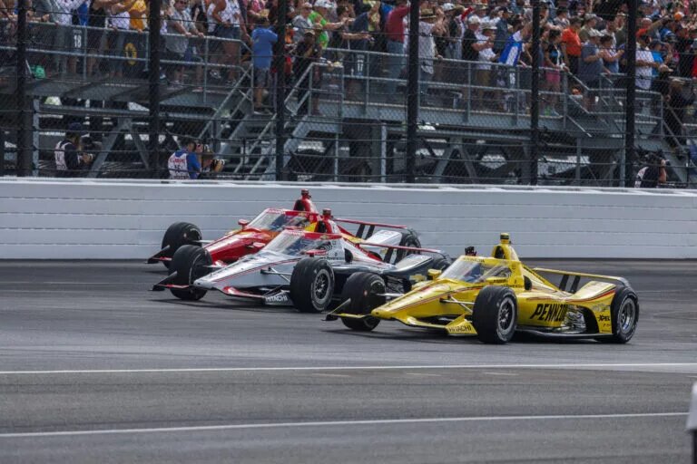 May 26, 2024, Indianapolis, Indiana, United States: Race car driver Will Power, Scott McLaughlin, and Josef Newgarden, all of Team Penske, lead a parade lap through turn one during the 2024 Indy 500 at Indianapolis Motor Speedway. Indianapolis United States