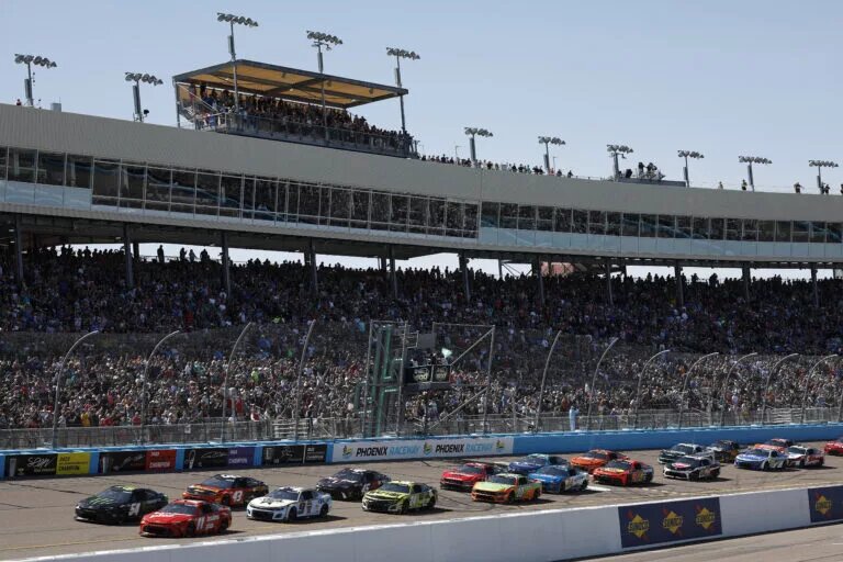 AVONDALE, ARIZONA - MARCH 10: Denny Hamlin, driver of the #11 Mavis Brakes Plus Toyota, and Ty Gibbs, driver of the #54 Monster Energy Toyota, lead the field to start the NASCAR Cup Series Shriners Children's 500 at Phoenix Raceway on March 10, 2024 in Avondale, Arizona. (Photo by Chris Graythen/Getty Images)