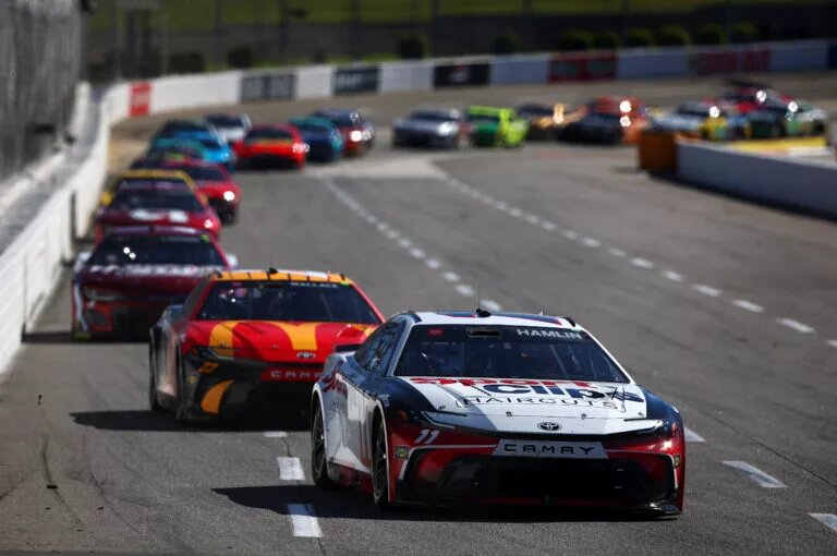 MARTINSVILLE, VIRGINIA - APRIL 07: Denny Hamlin, driver of the #11 Sport Clips Haircuts Toyota, and Bubba Wallace, driver of the #23 McDonald's Toyota, race during the NASCAR Cup Series Cook Out 400 at Martinsville Speedway on April 07, 2024 in Martinsville, Virginia. (Photo by Jared C. Tilton/Getty Images)