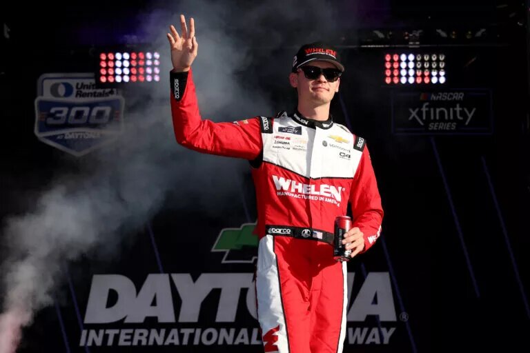DAYTONA BEACH, FLORIDA - FEBRUARY 15: Jesse Love, driver of the #2 Whelen Chevrolet waves to fans as he walks onstage during driver intros prior to the NASCAR Xfinity Series United Rentals 300 at Daytona International Speedway on February 15, 2025 in Daytona Beach, Florida. (Photo by Meg Oliphant/Getty Images)