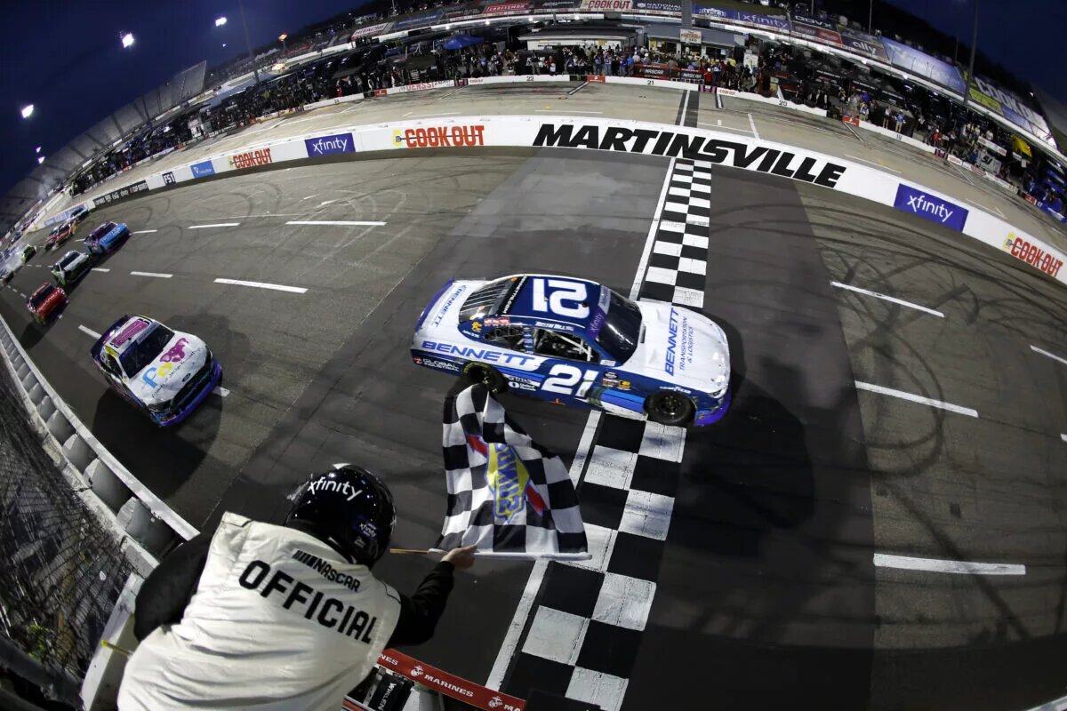 MARTINSVILLE, VIRGINIA - MARCH 29: Austin Hill, driver of the #21 Bennett Transportation Chevrolet, takes the checkered flag to win the NASCAR Xfinity Series US Marine Corps 250 at Martinsville Speedway on March 29, 2025 in Martinsville, Virginia. (Photo by Logan Riely/Getty Images)