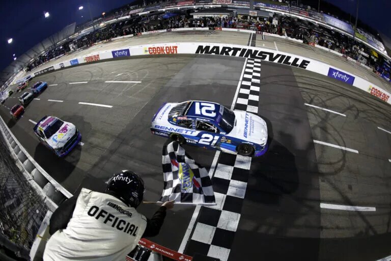 MARTINSVILLE, VIRGINIA - MARCH 29: Austin Hill, driver of the #21 Bennett Transportation Chevrolet, takes the checkered flag to win the NASCAR Xfinity Series US Marine Corps 250 at Martinsville Speedway on March 29, 2025 in Martinsville, Virginia. (Photo by Logan Riely/Getty Images)