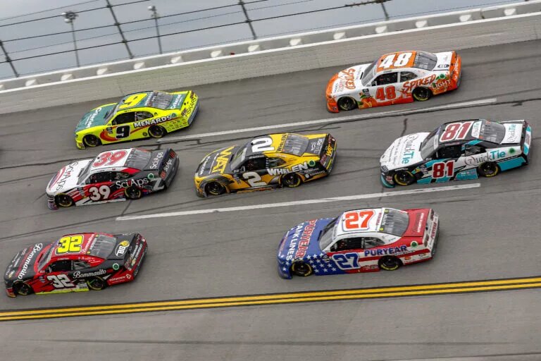 TALLADEGA, ALABAMA - APRIL 20: Jordan Anderson, driver of the #32 Bommarito Automotive Group Chevrolet, Ryan Sieg, driver of the #39 Sci Aps Ford, Brandon Jones, driver of the #9 Menards/Criterion Appliances Chevrolet, Jesse Love, driver of the #2 WAT Chevrolet, Jeb Burton, driver of the #27 Puryear Tank Lines Chevrolet, Chandler Smith, driver of the #81 QuickTie Toyota, and Parker Kligerman, driver of the #48 Spiked Lite Coolers Chevrolet, race during the NASCAR Xfinity Series Ag-Pro 300 at Talladega Superspeedway on April 20, 2024 in Talladega, Alabama. (Photo by Sean Gardner/Getty Images)