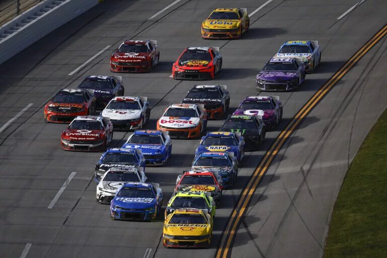 TALLADEGA, ALABAMA - APRIL 21: Joey Logano, driver of the #22 Shell Pennzoil Ford, and Kyle Larson, driver of the #5 HendrickCars.com Chevrolet, lead the field during the NASCAR Cup Series GEICO 500 at Talladega Superspeedway on April 21, 2024 in Talladega, Alabama. (Photo by Sean Gardner/Getty Images)