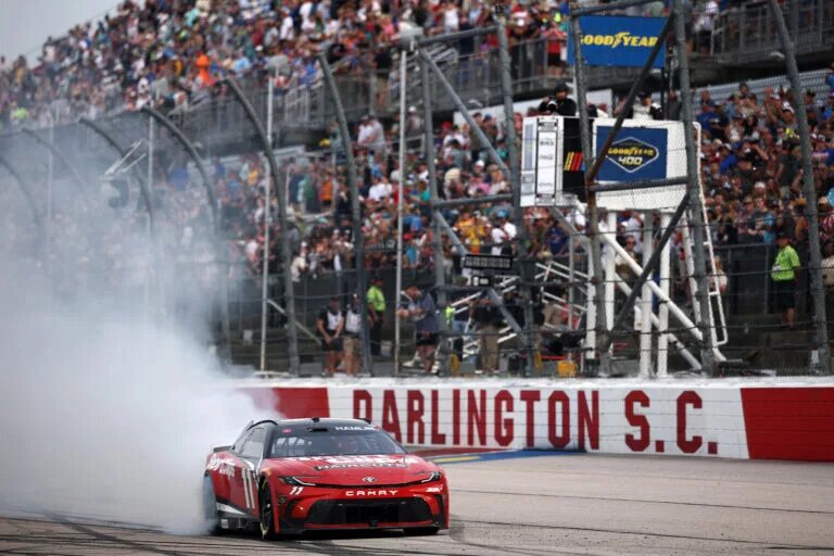 DARLINGTON, SOUTH CAROLINA - APRIL 06: Denny Hamlin, driver of the #11 Sport Clips Haircuts Toyota, celebrates with a burnout after winning the NASCAR Cup Series Goodyear 400 at Darlington Raceway on April 06, 2025 in Darlington, South Carolina. (Photo by Jared C. Tilton/Getty Images)