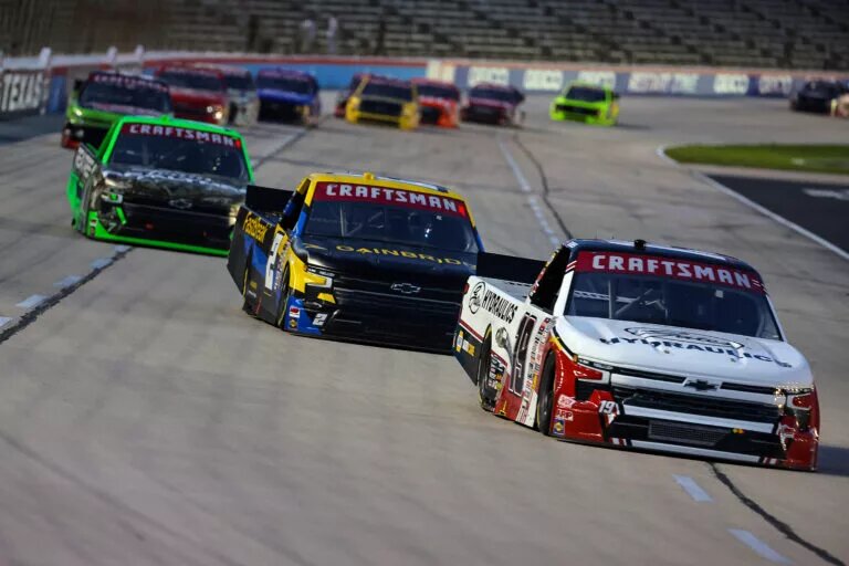FORT WORTH, TEXAS - APRIL 12: Christian Eckes, driver of the #19 Gates Hydraulics Chevrolet, Nick Sanchez, driver of the #2 Gainbridge Chevrolet, and Kyle Busch, driver of the #7 Realtree Chevrolet, race during the NASCAR Craftsman Truck Series SpeedyCash.com 250 at Texas Motor Speedway on April 12, 2024 in Fort Worth, Texas.