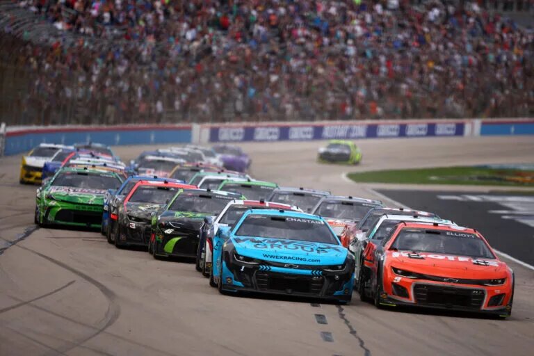 FORT WORTH, TEXAS - APRIL 14: Chase Elliott, driver of the #9 Hooters Chevrolet, and Ross Chastain, driver of the #1 Worldwide Express Chevrolet, lead the field to a restart during the NASCAR Cup Series AutoTrader EchoPark Automotive 400 at Texas Motor Speedway on April 14, 2024 in Fort Worth, Texas.