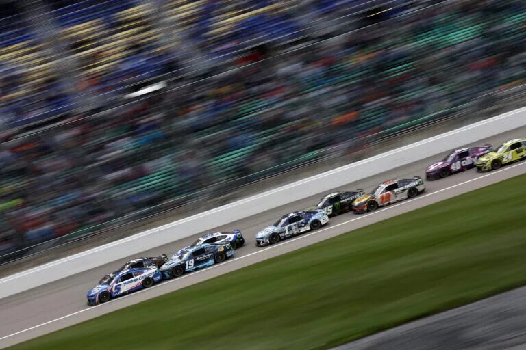 KANSAS CITY, KANSAS - MAY 05: Kyle Larson, driver of the #5 HendrickCars.com Chevrolet, Martin Truex Jr., driver of the #19 Auto-Owners Insurance Toyota, and Ross Chastain, driver of the #1 Busch Light Crocs Chevrolet, race during the NASCAR Cup Series AdventHealth 400 at Kansas Speedway on May 05, 2024 in Kansas City, Kansas. (Photo by Sean Gardner/Getty Images)